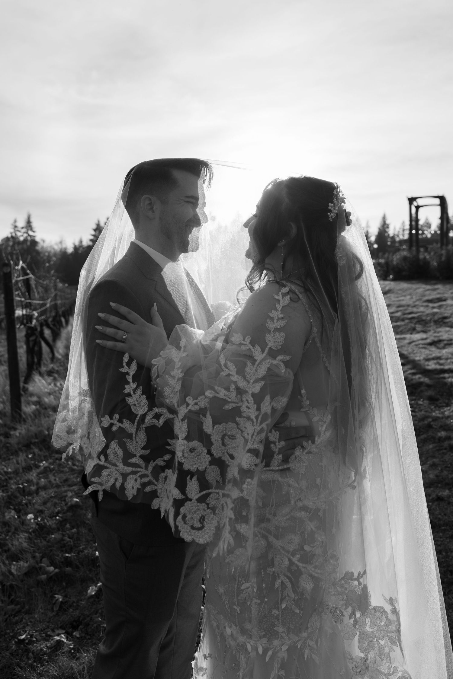 Black and white wedding portrait showcasing intricate lace veil details.