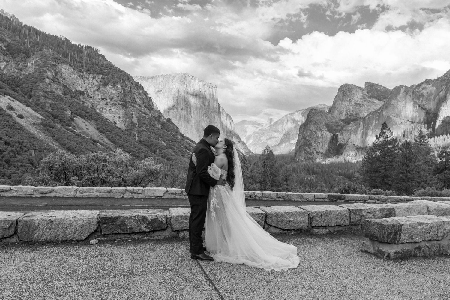 Wedding couple poses for romantic silhouettes against Yosemite's iconic granite cliffs and valley views.