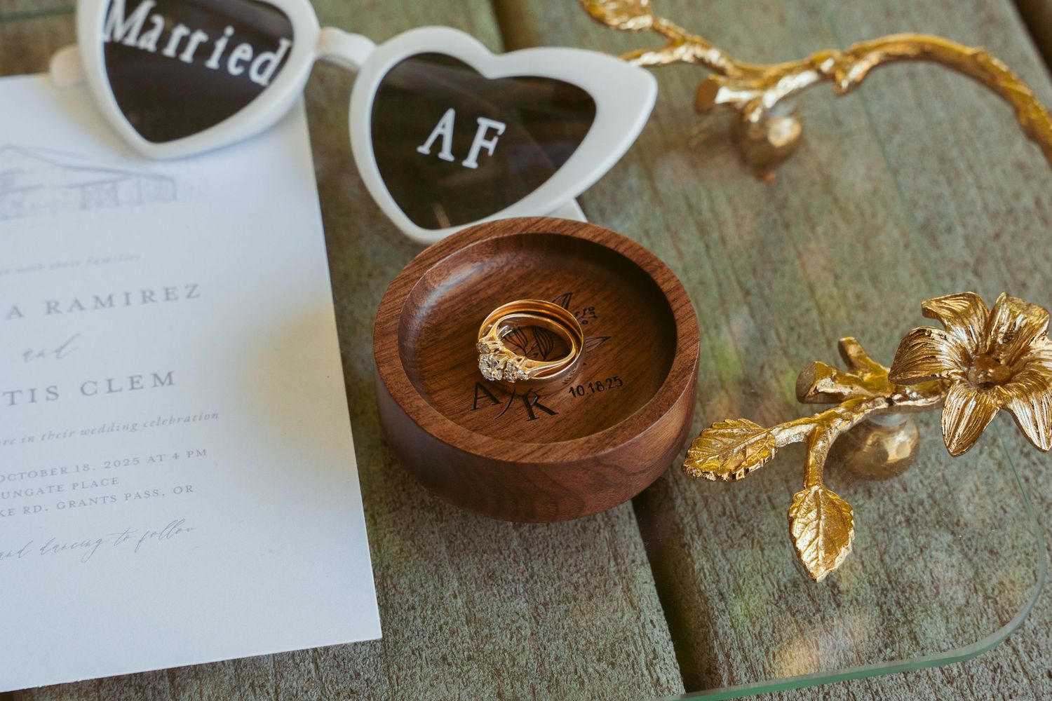 Wedding accessories and sunglasses displayed with 'Married AF' text on wooden surface.