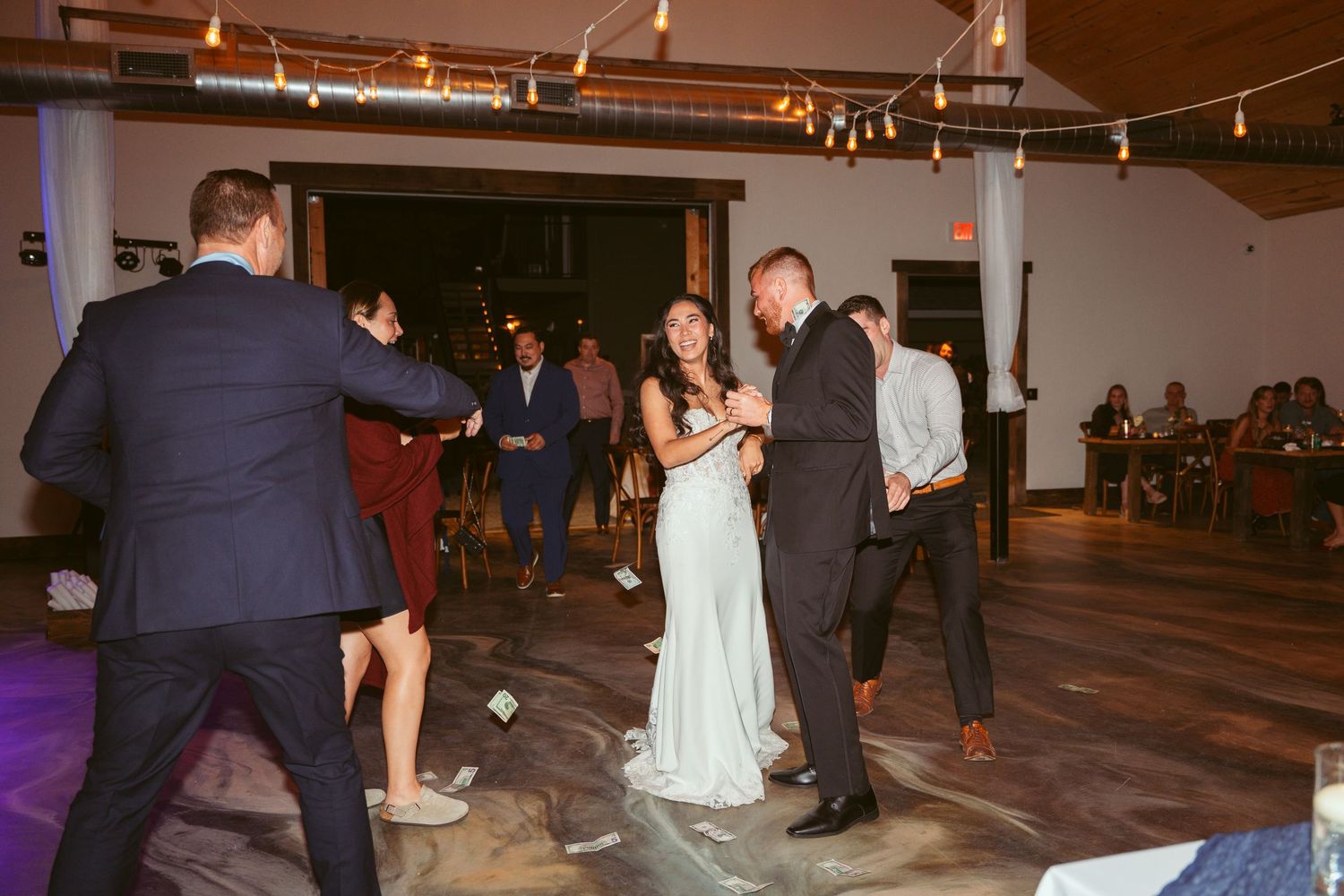 Guests enjoying a lively dance party at an indoor wedding reception venue.
