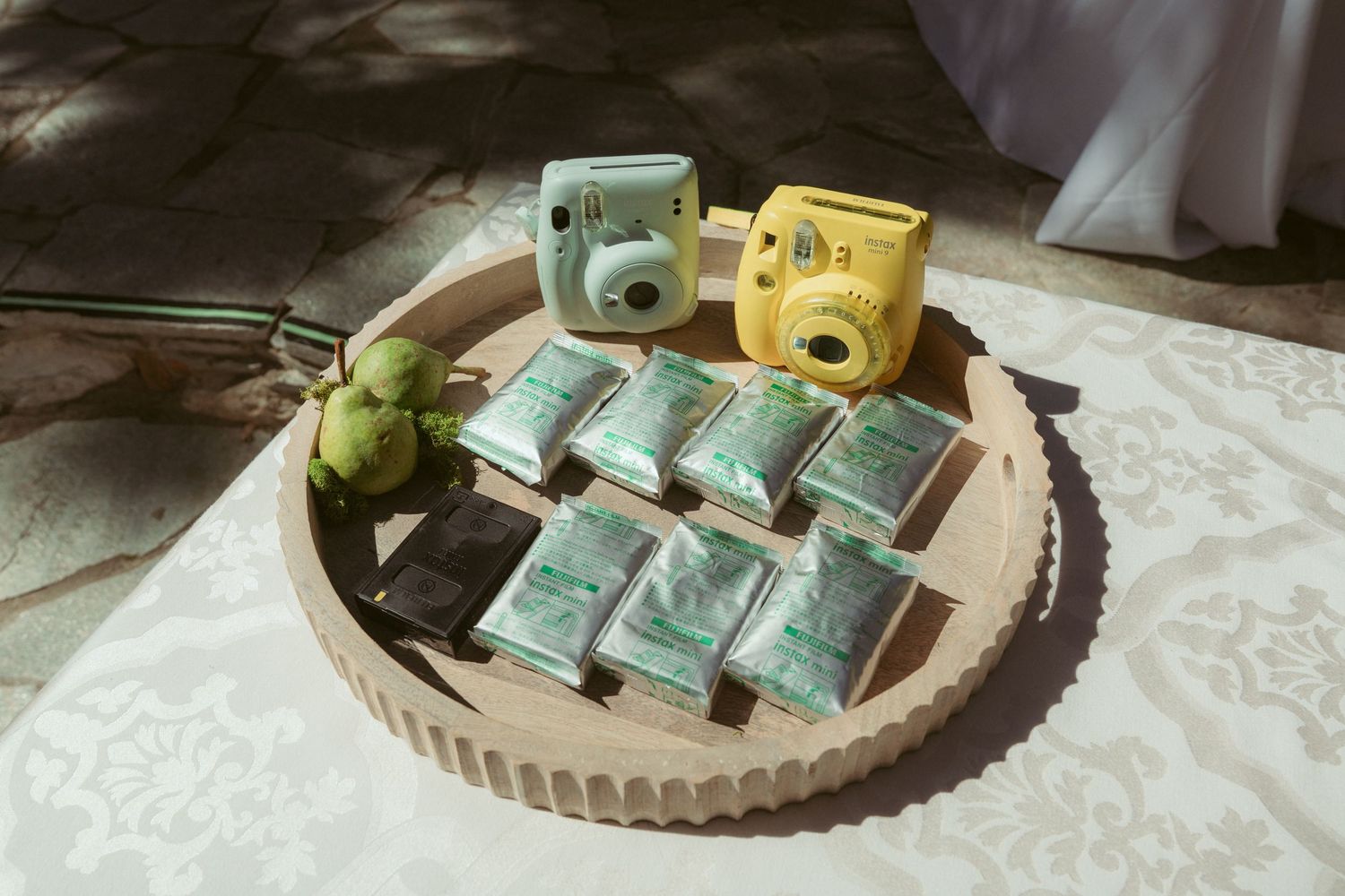 Vintage cameras displayed on white tablecloth for wedding photography.