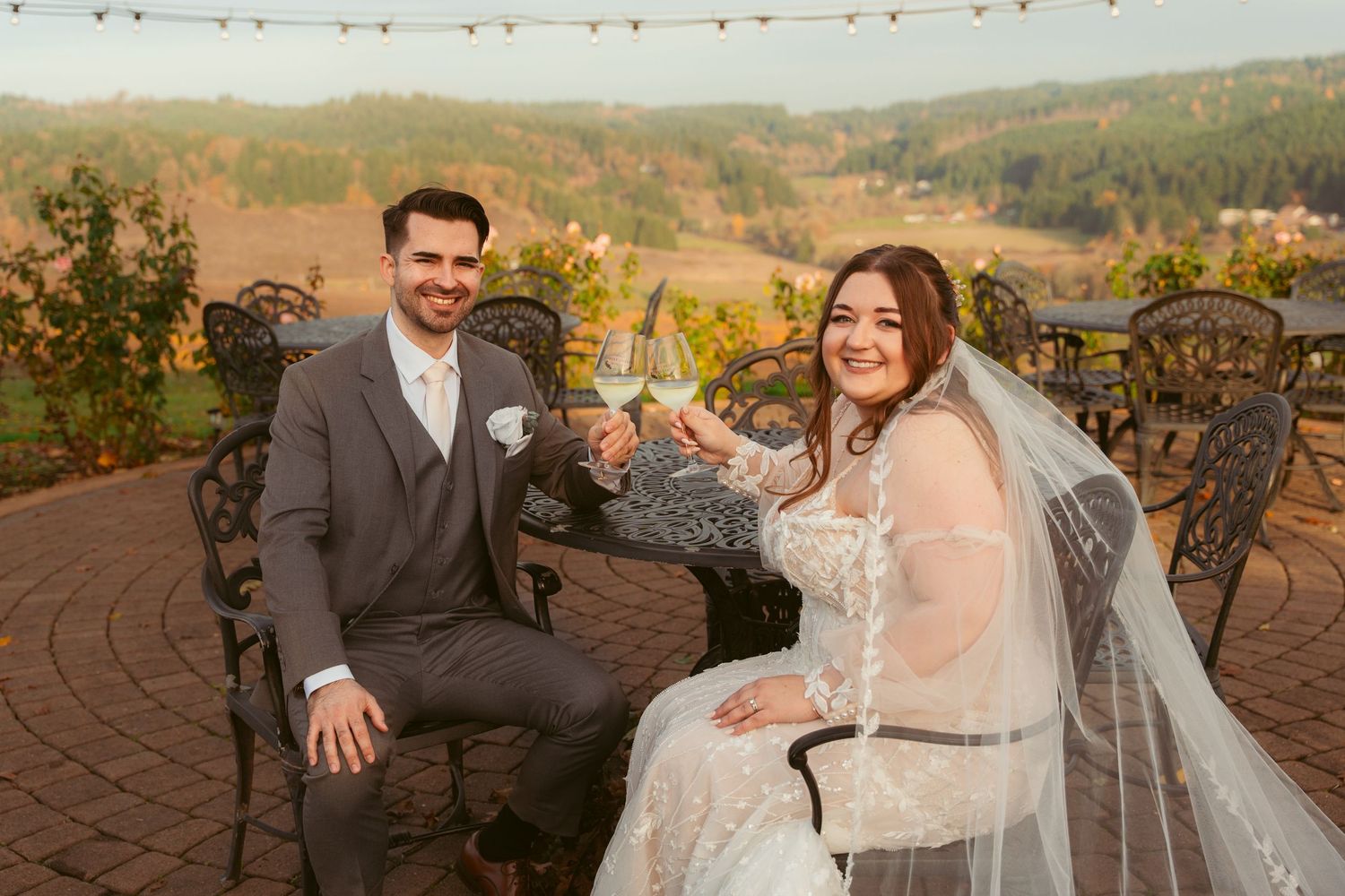 Wedding couple enjoys intimate moments during sunset photo session at vineyard venue.