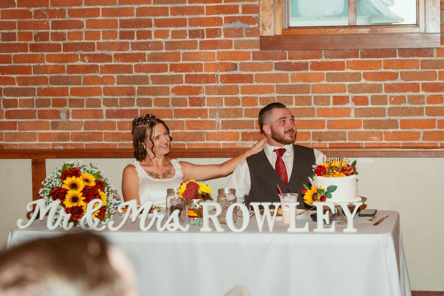 Elegant wedding venue interior featuring exposed brick walls and decorative lighting.