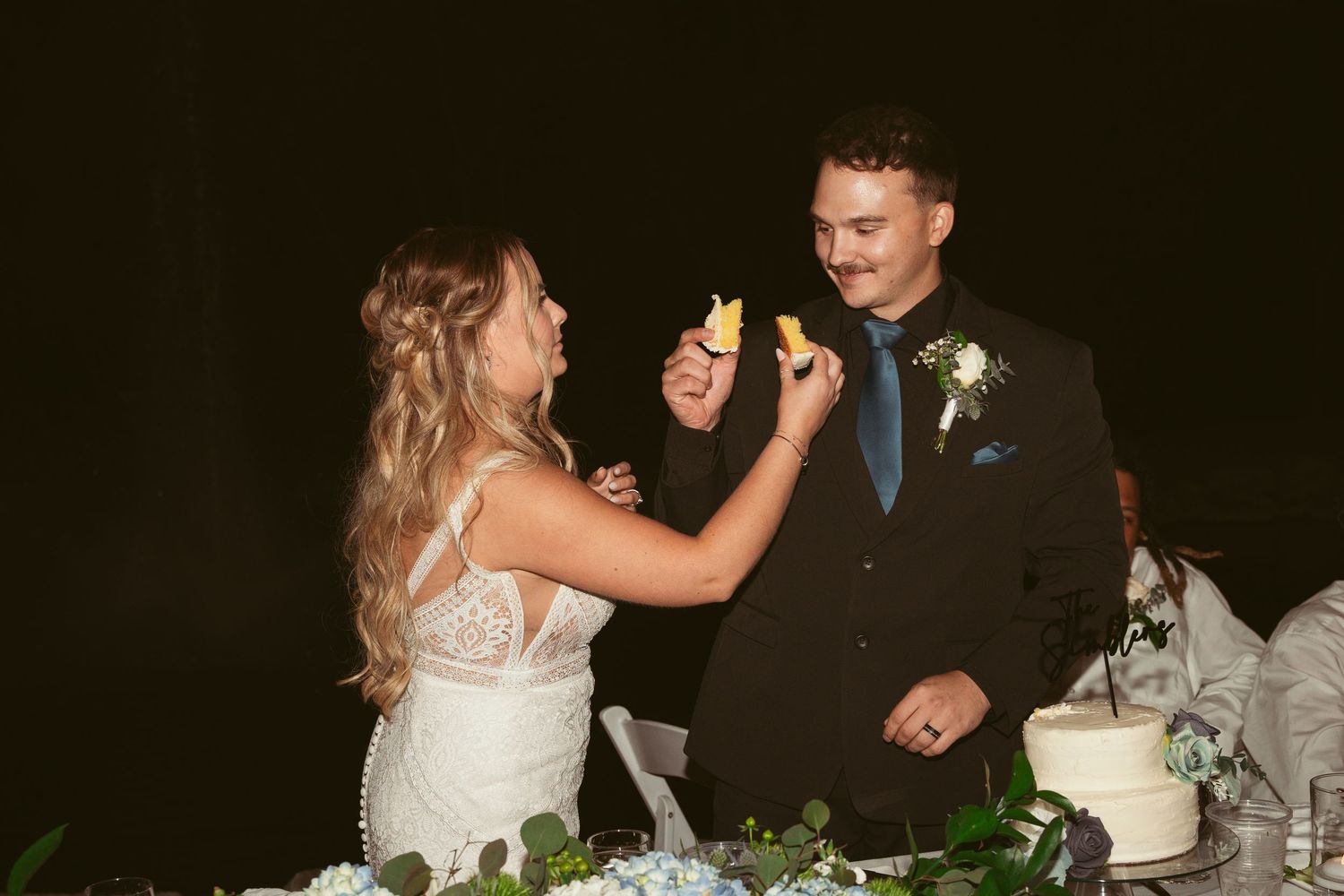 A bride and groom share a romantic dance together during their wedding reception celebration.