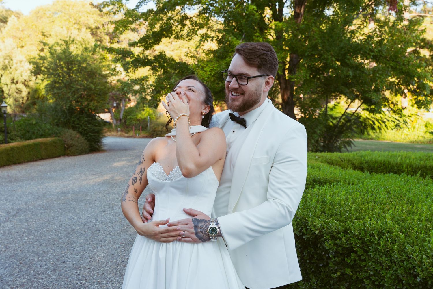 A couple shares a romantic moment on a winding garden path.