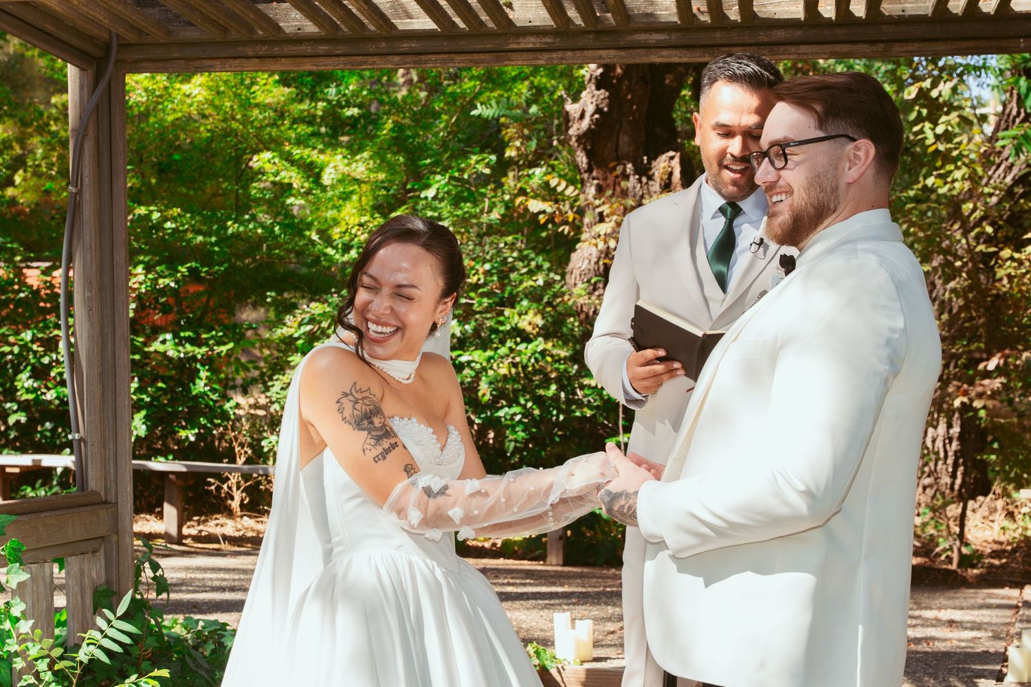 Joyful wedding celebration moments captured under wooden pergola in garden setting.