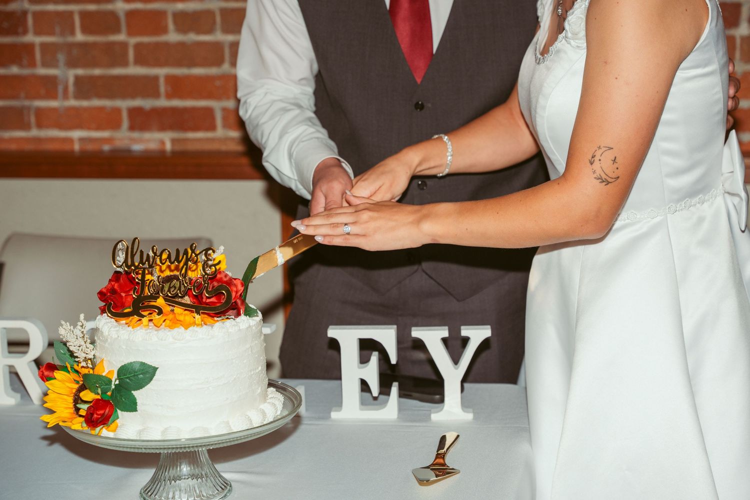 Wedding cake and dessert table display with white frosting and floral decorations.