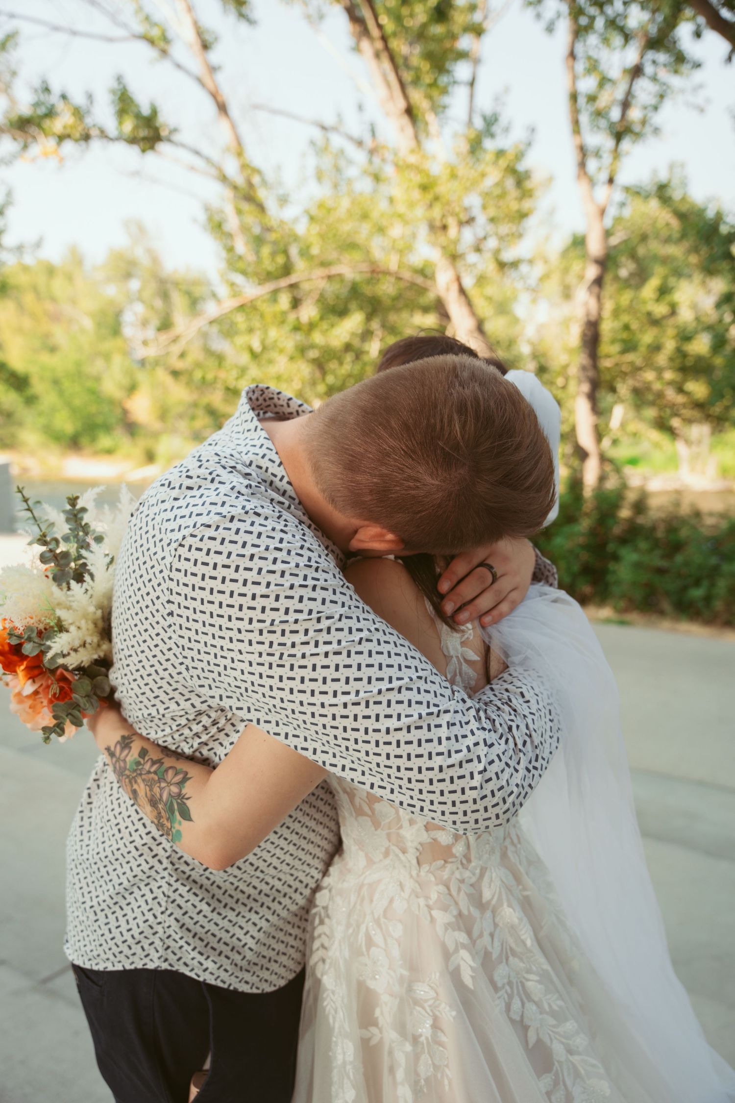 Couple sharing an intimate moment outdoors during their wedding photoshoot.