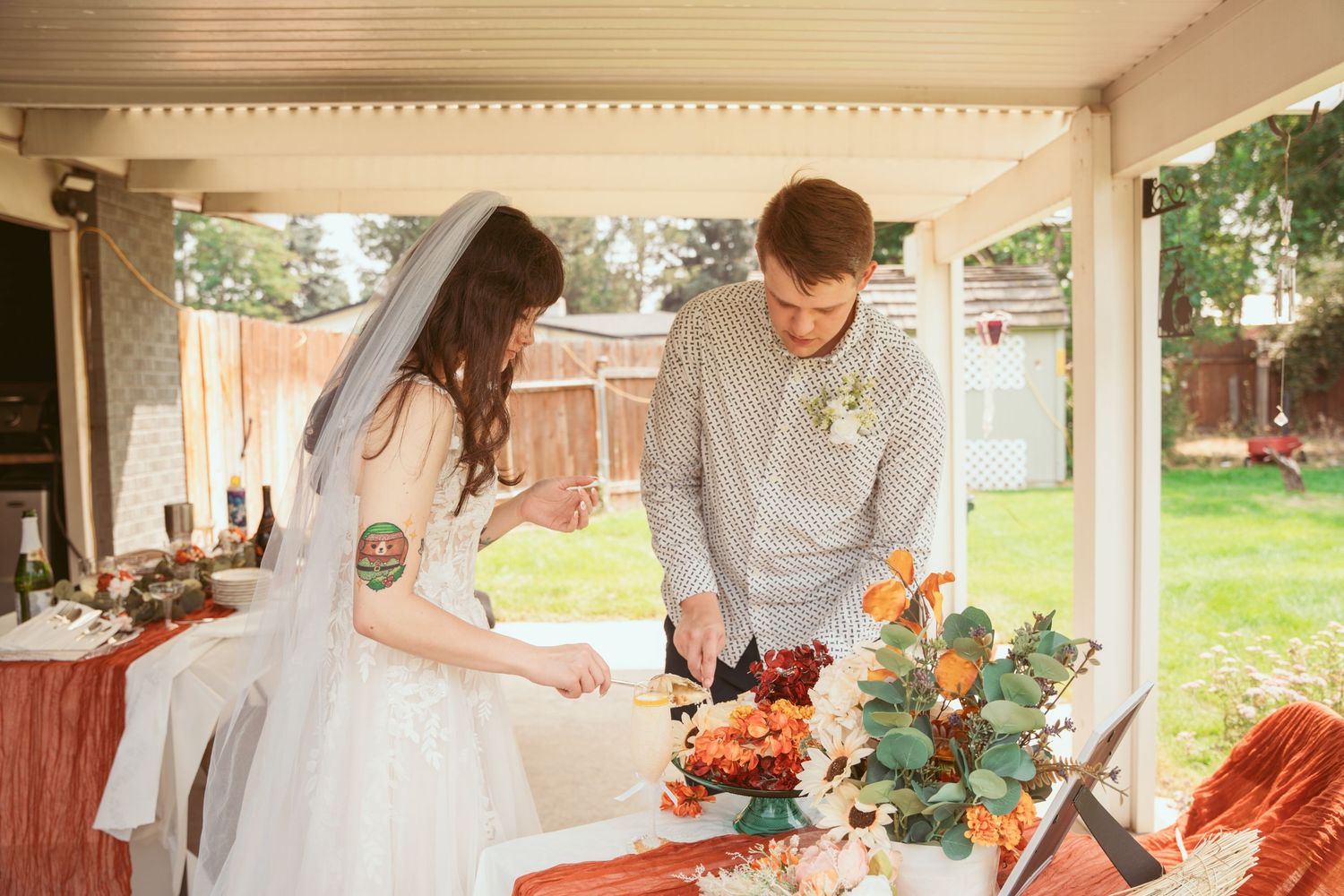 A sunlit indoor space decorated with floral arrangements and rustic elements.