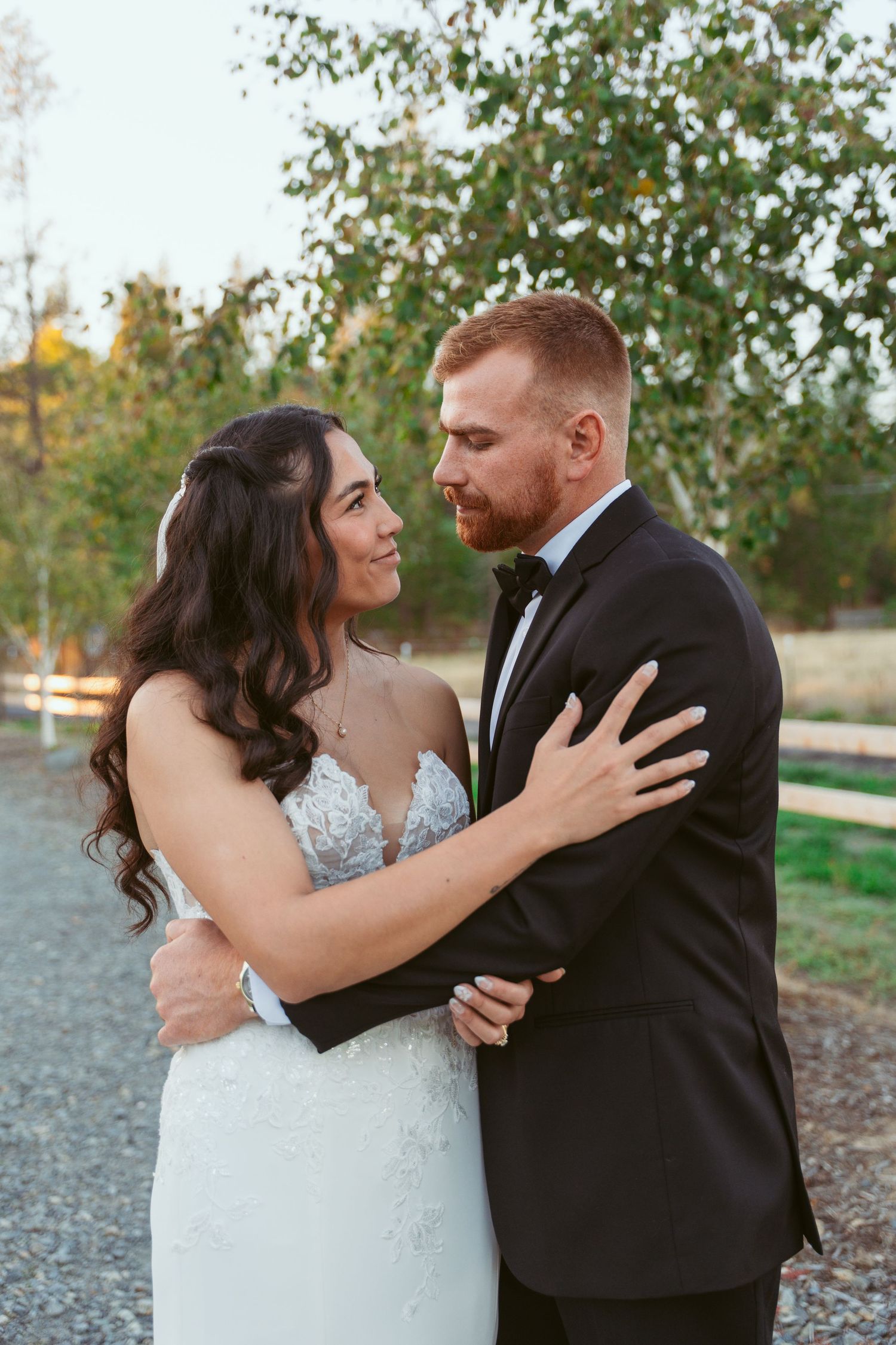 Wedding couple shares emotional moment together in a natural outdoor setting.