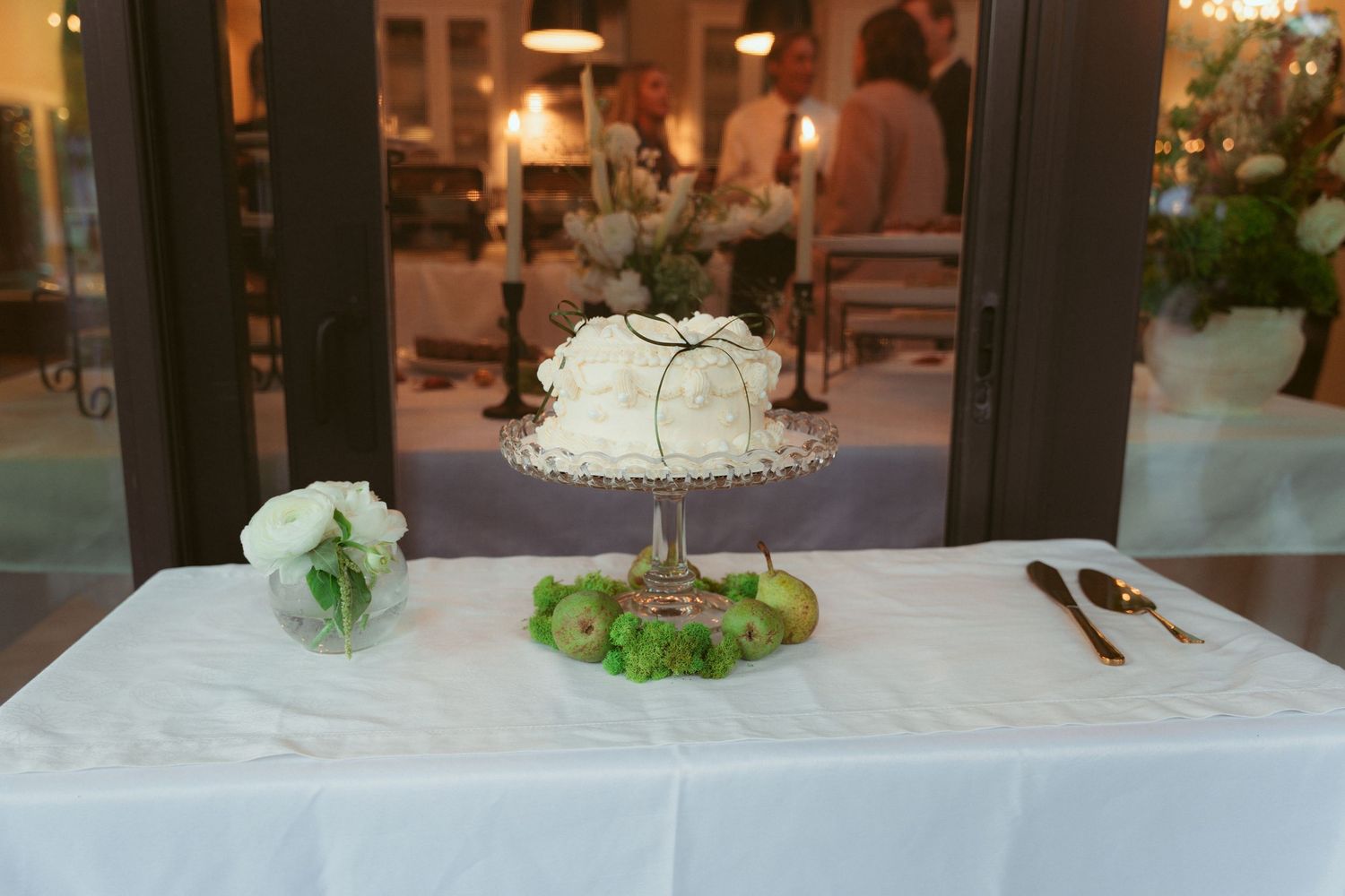 White tablecloth covered event space with elegant floral centerpieces and decor.