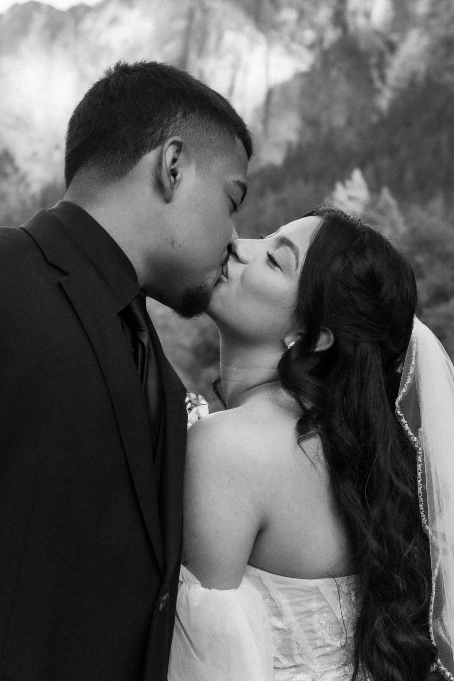Black and white wedding photos capture tender moments between newlyweds in a romantic sequence.