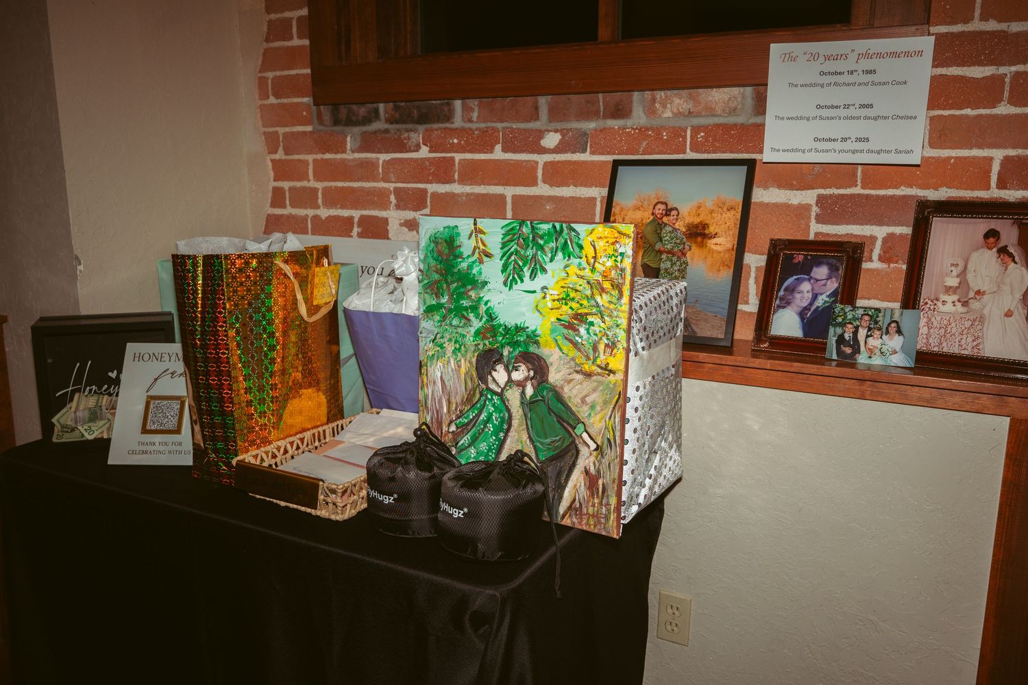Artwork and decorative pieces displayed along a brick wall at an event venue.