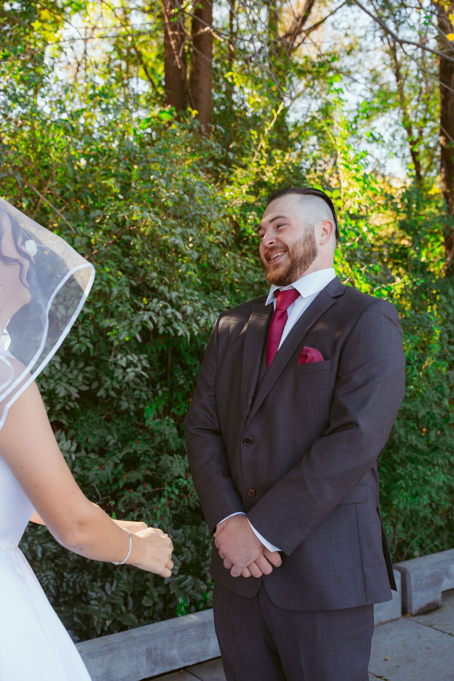 Wedding first look sequence showing couple's reactions in an outdoor garden setting.