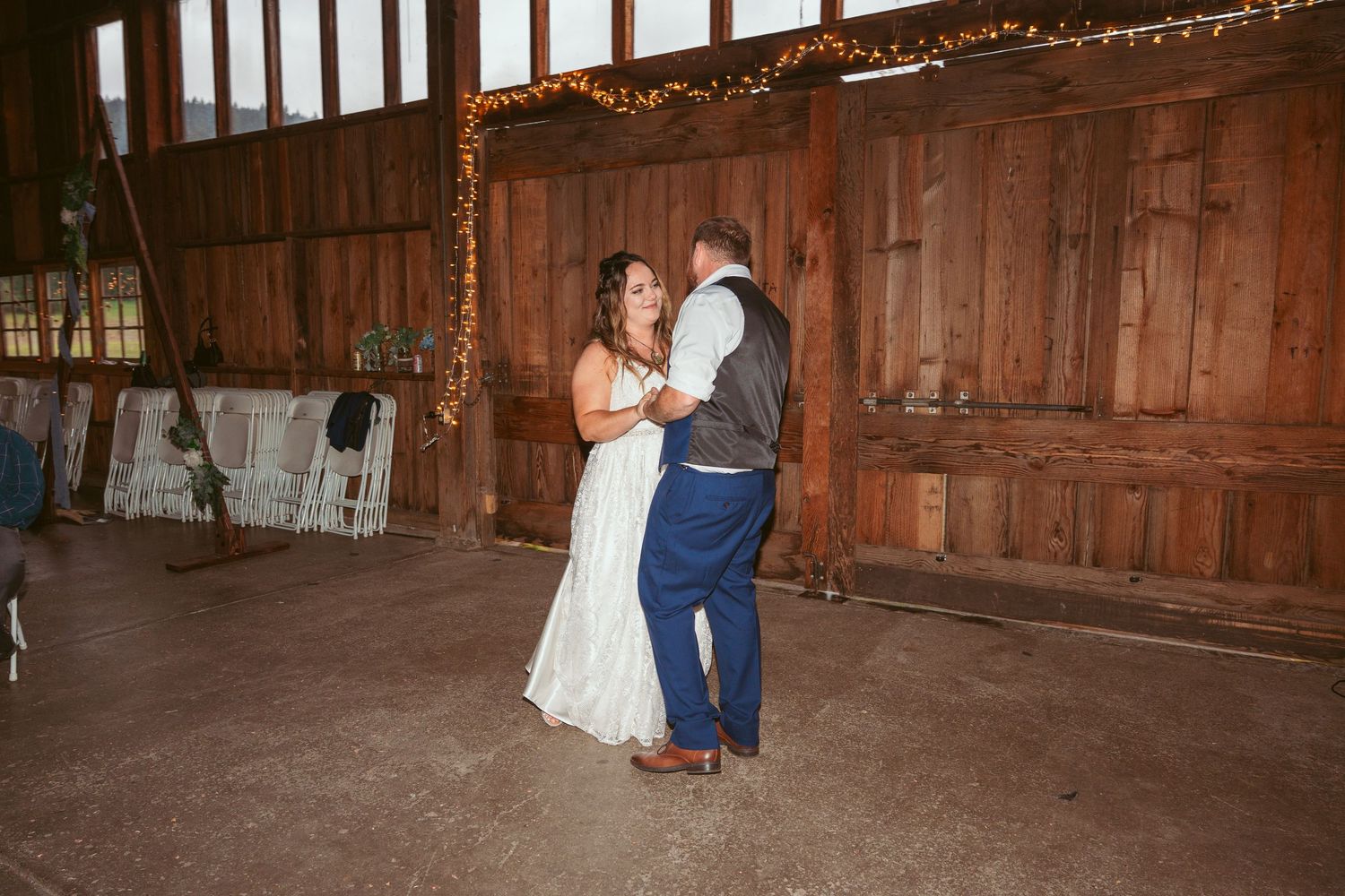 A romantic dance sequence in a wooden barn with twinkling lights overhead.