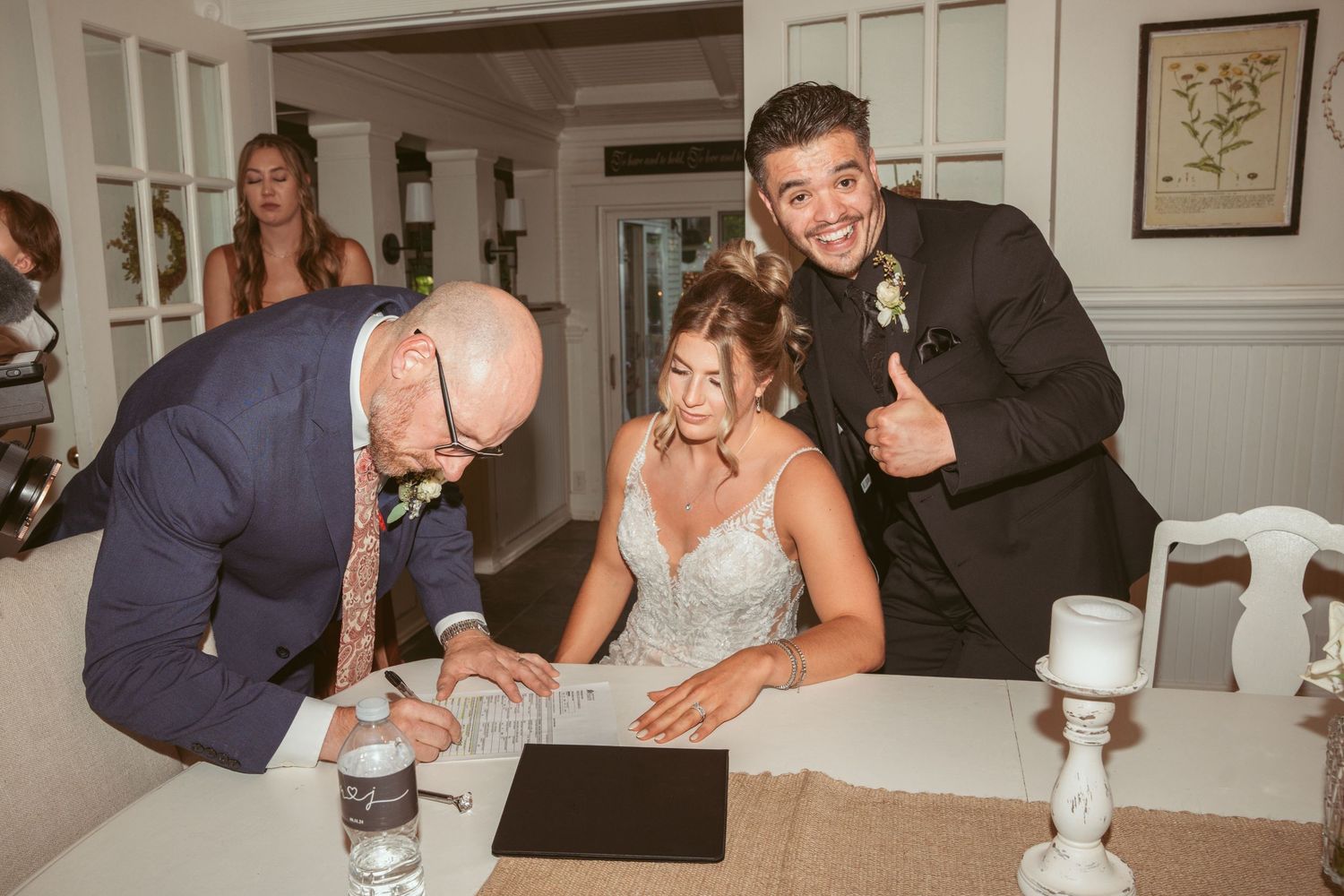 Candid moments captured during an indoor wedding reception with guests at tables.