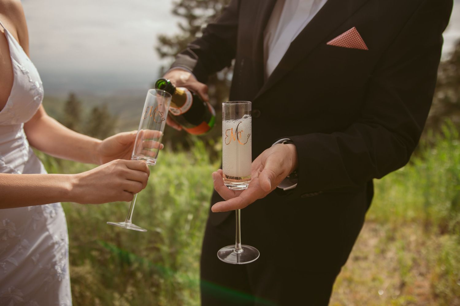 Close-up shots of champagne glasses being held during an outdoor wedding celebration.
