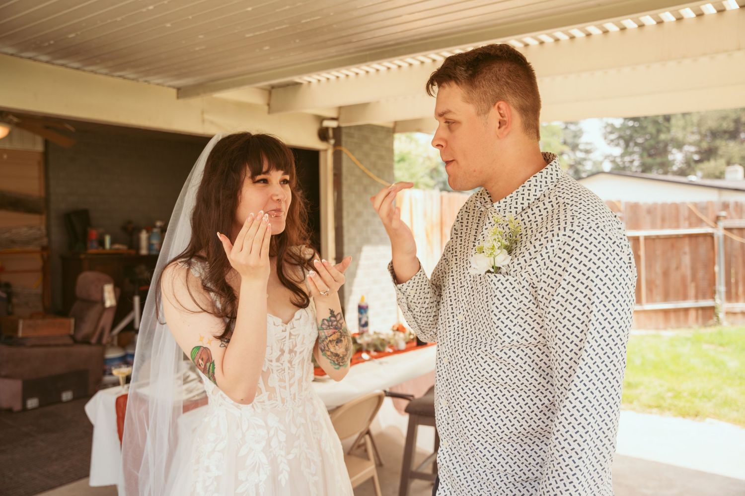 Outdoor wedding celebration with rustic wooden beams and natural lighting.