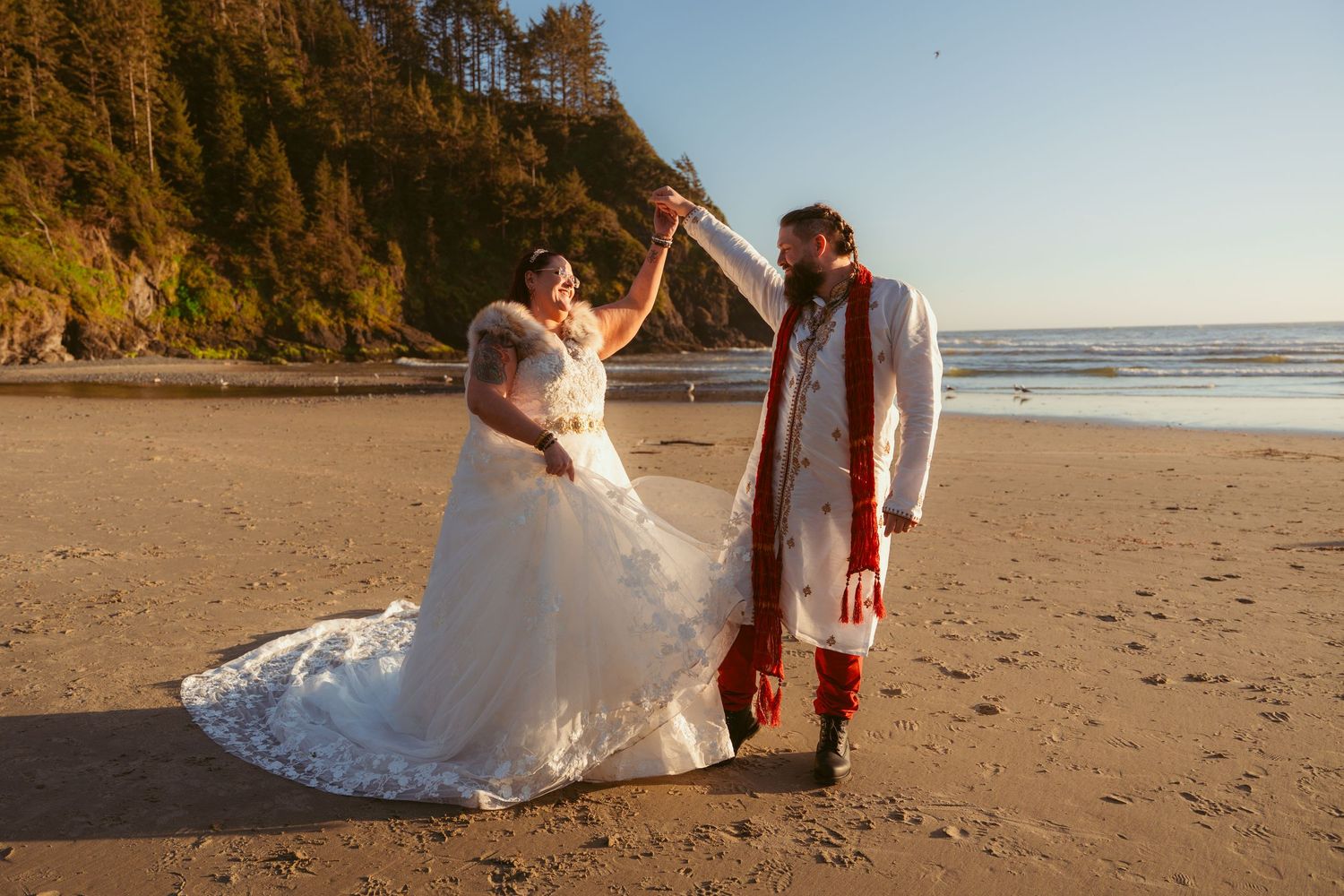 A dreamy beach scene with two people dancing as sunlight filters through the coastal trees.