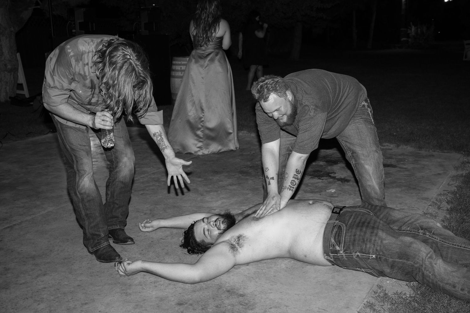 Black and white photo of people performing staged wrestling moves at an event.