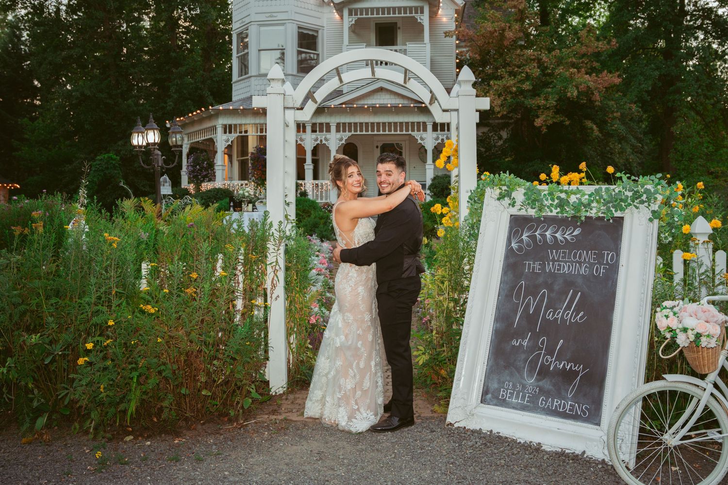 Outdoor wedding ceremony setup with white gazebo and chalkboard signs.