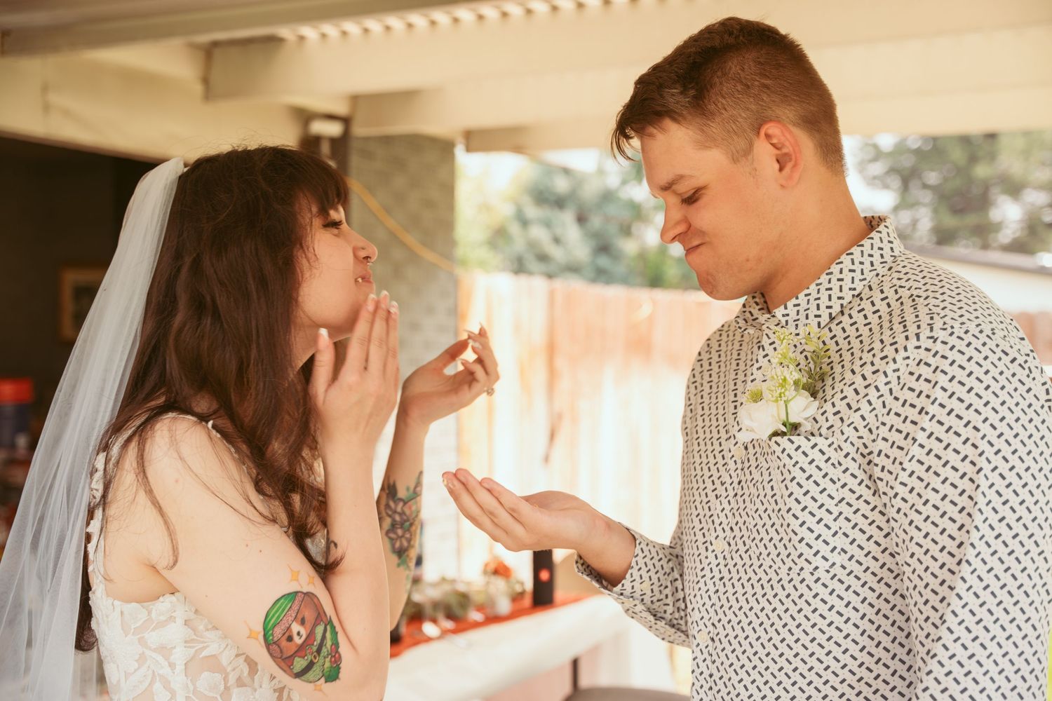 Romantic moment captured during an outdoor wedding celebration with rustic decor.