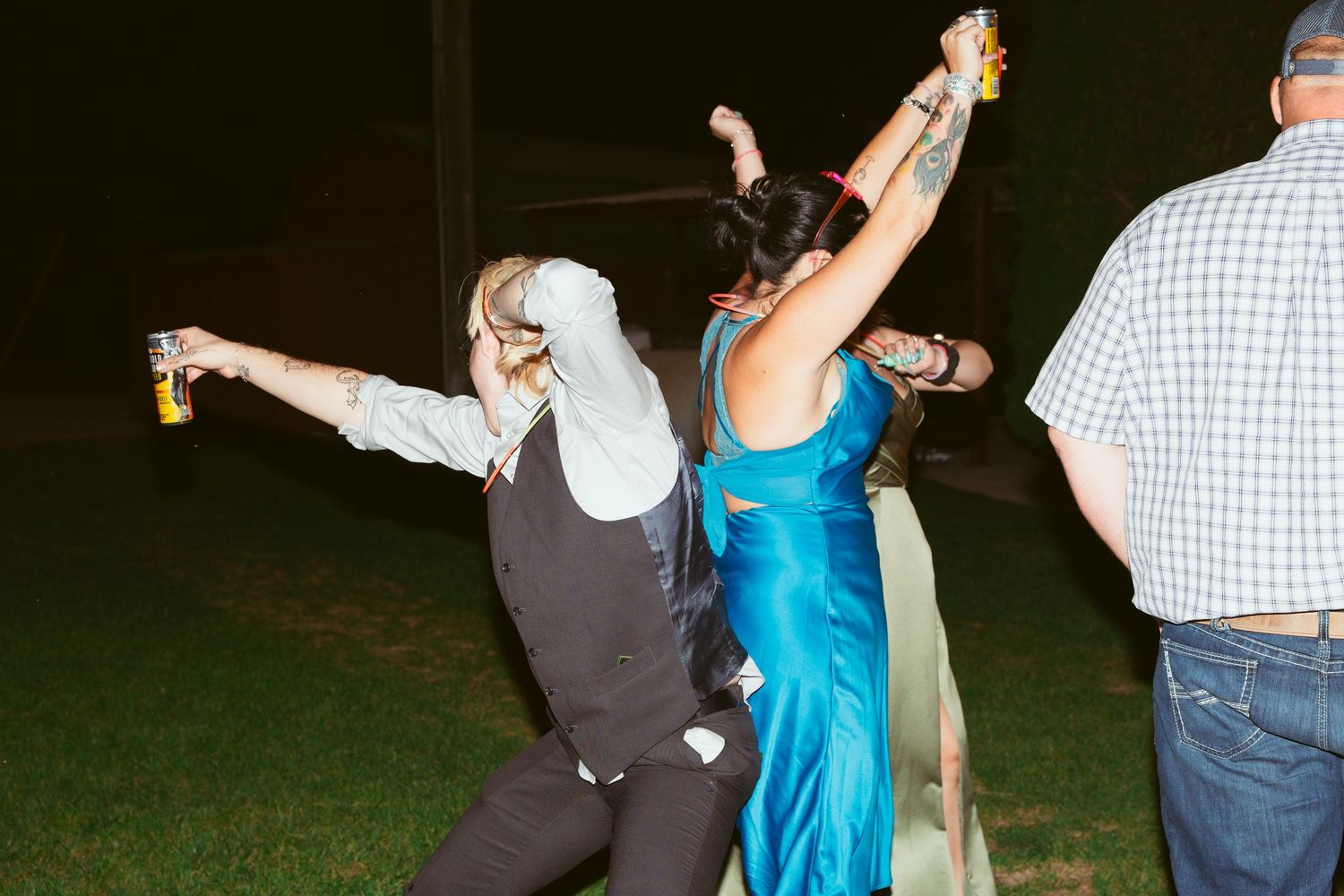 Couples dancing together at an outdoor evening wedding reception.
