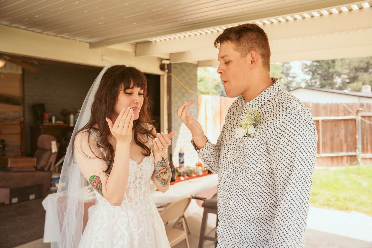 Couple in wedding attire sharing tender moments in a rustic indoor setting.