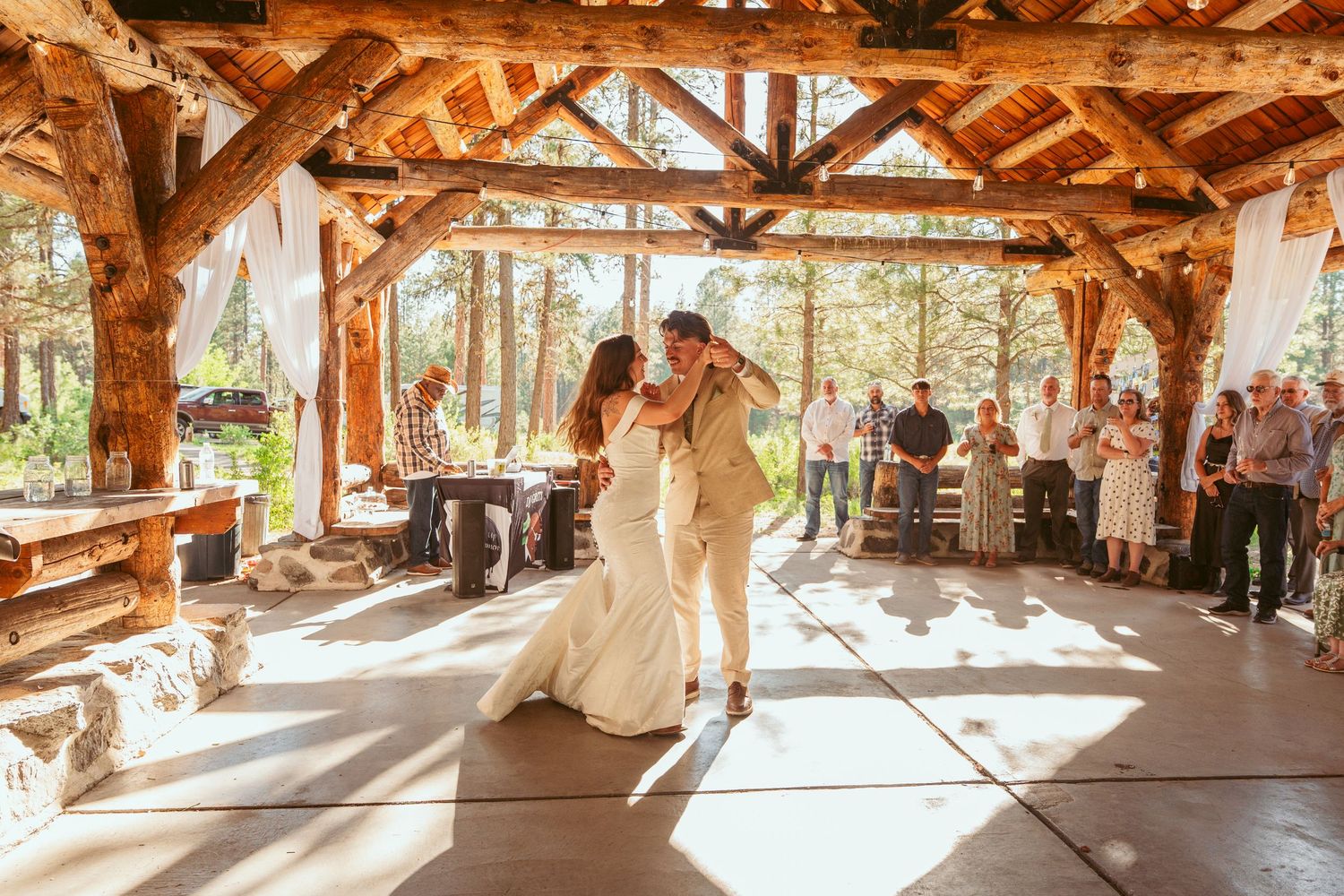 Panoramic view of a timber-frame barn wedding venue with natural lighting and wooden beams.