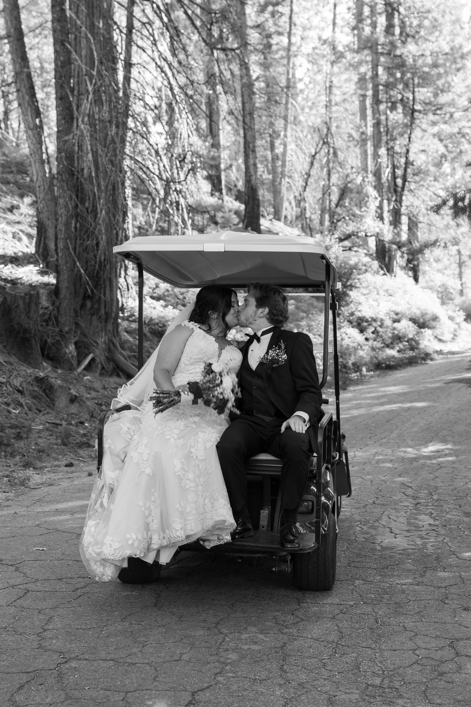 Black and white photos of newlyweds riding in a golf cart through a forest setting.