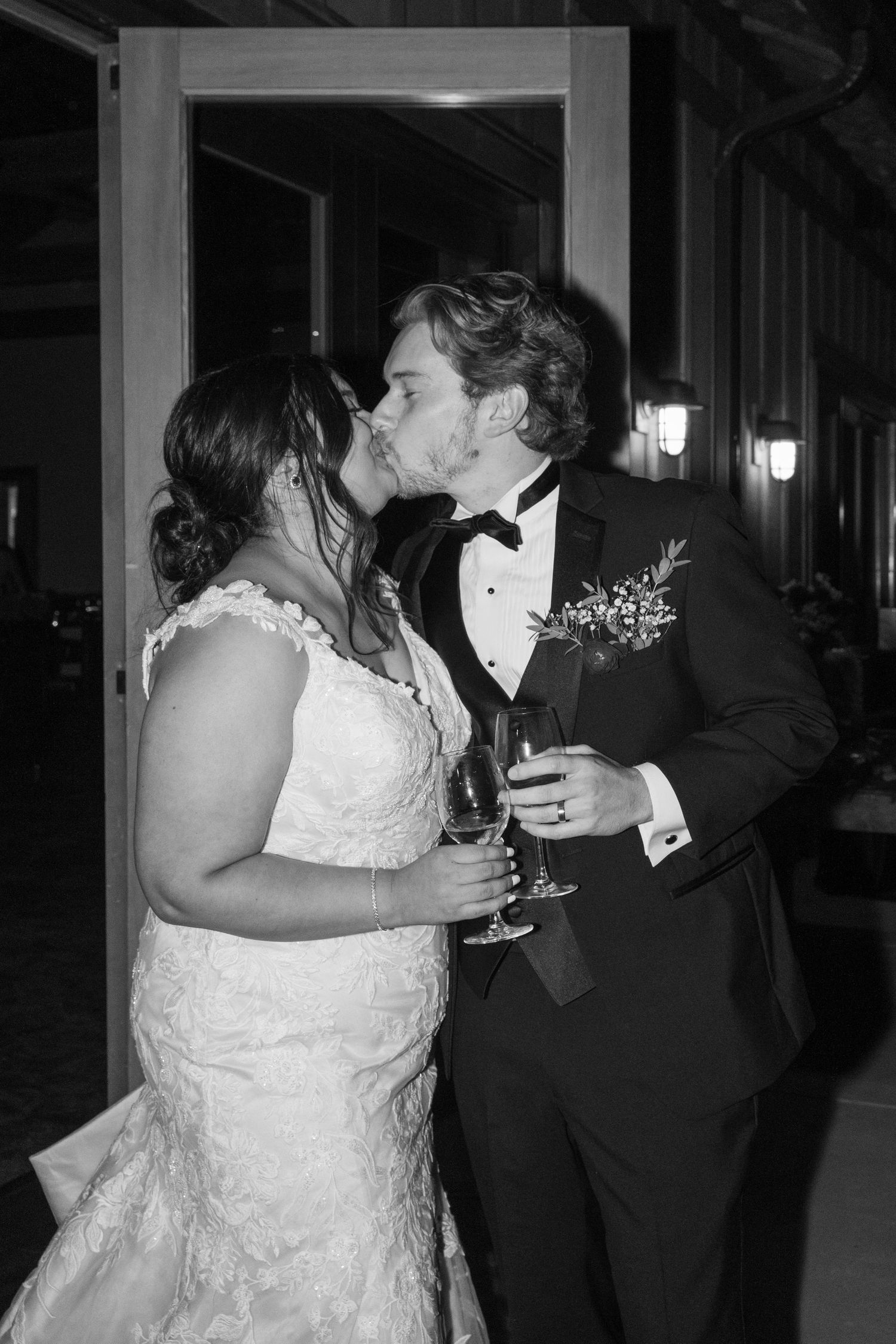 Intimate moments captured during an indoor evening wedding reception.