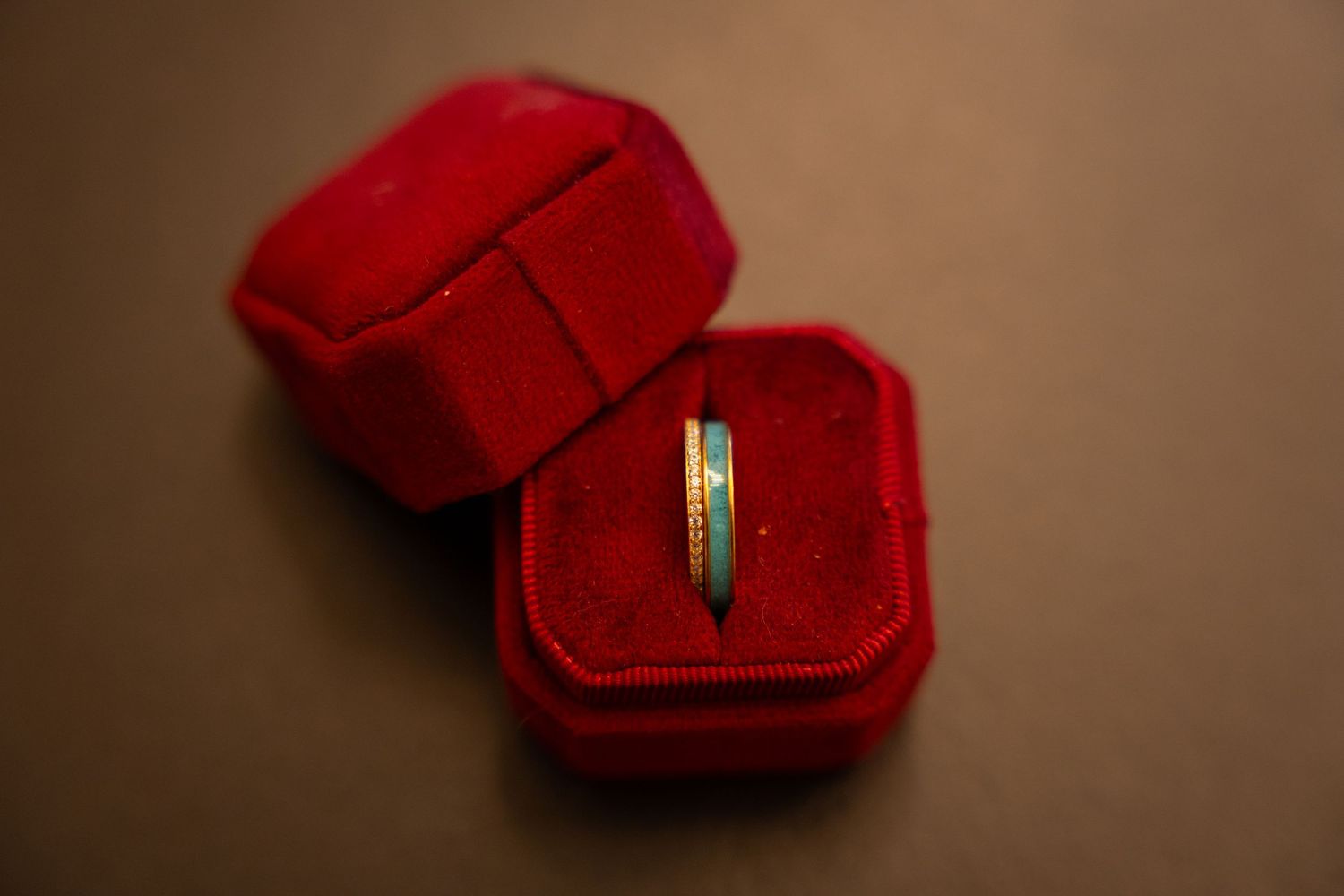 Close-up shots of red ring boxes arranged in a sequence on a dark background.