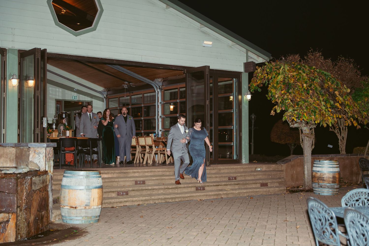 Exterior view of a modern event venue at night with warm lighting.