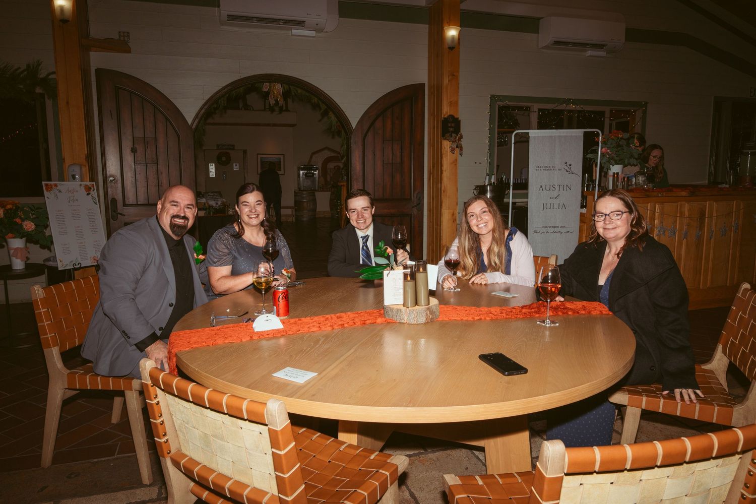 Diners enjoying conversation around circular tables in a cozy restaurant atmosphere.