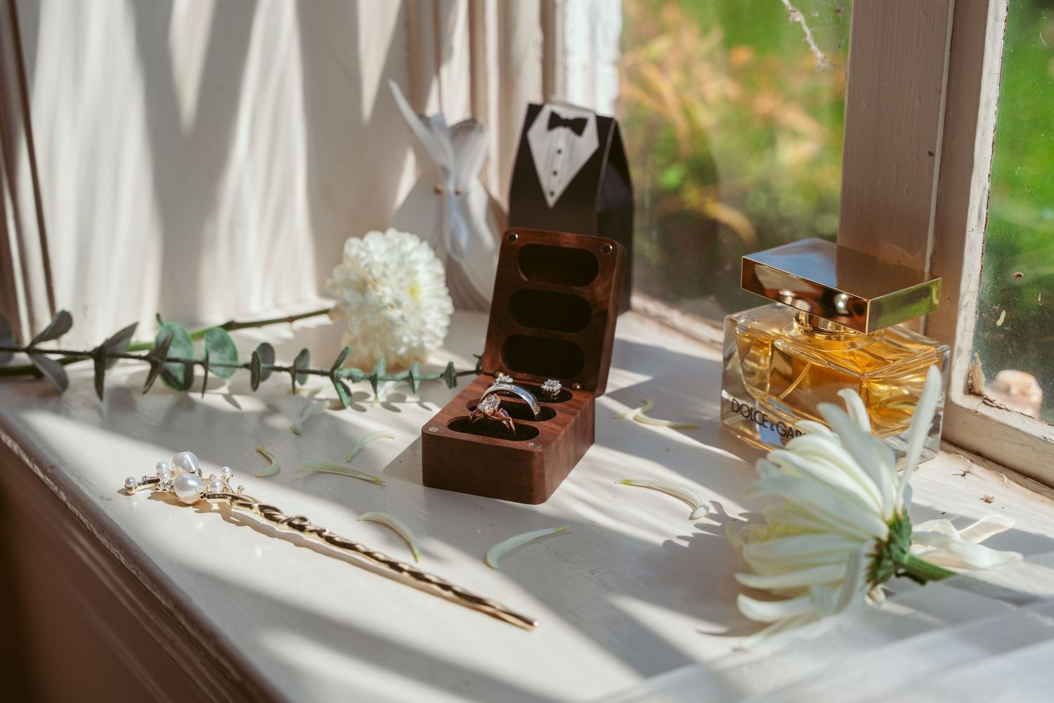 Elegant table settings with sunlight streaming through windows onto glassware and decorative elements.
