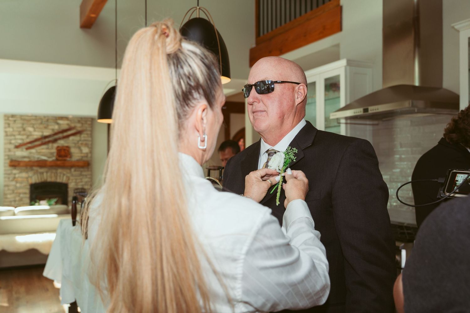 Wedding party members sharing emotional embraces during celebration.