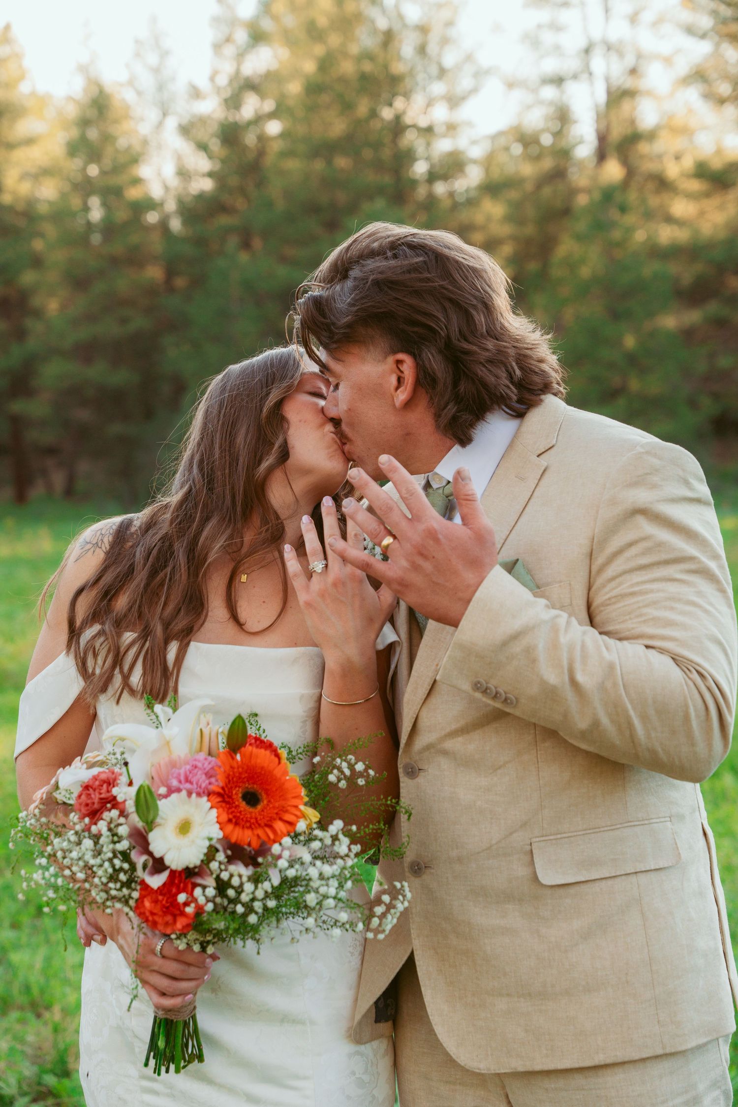 Intimate wedding portraits showing tender moments between couple with colorful bouquet in hand.