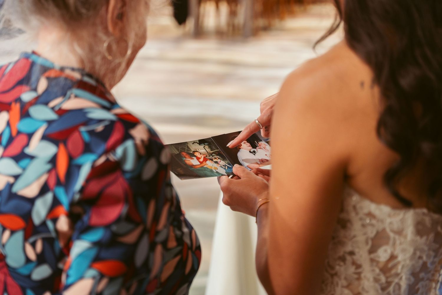Close-up view of wedding cake being cut during a reception celebration.