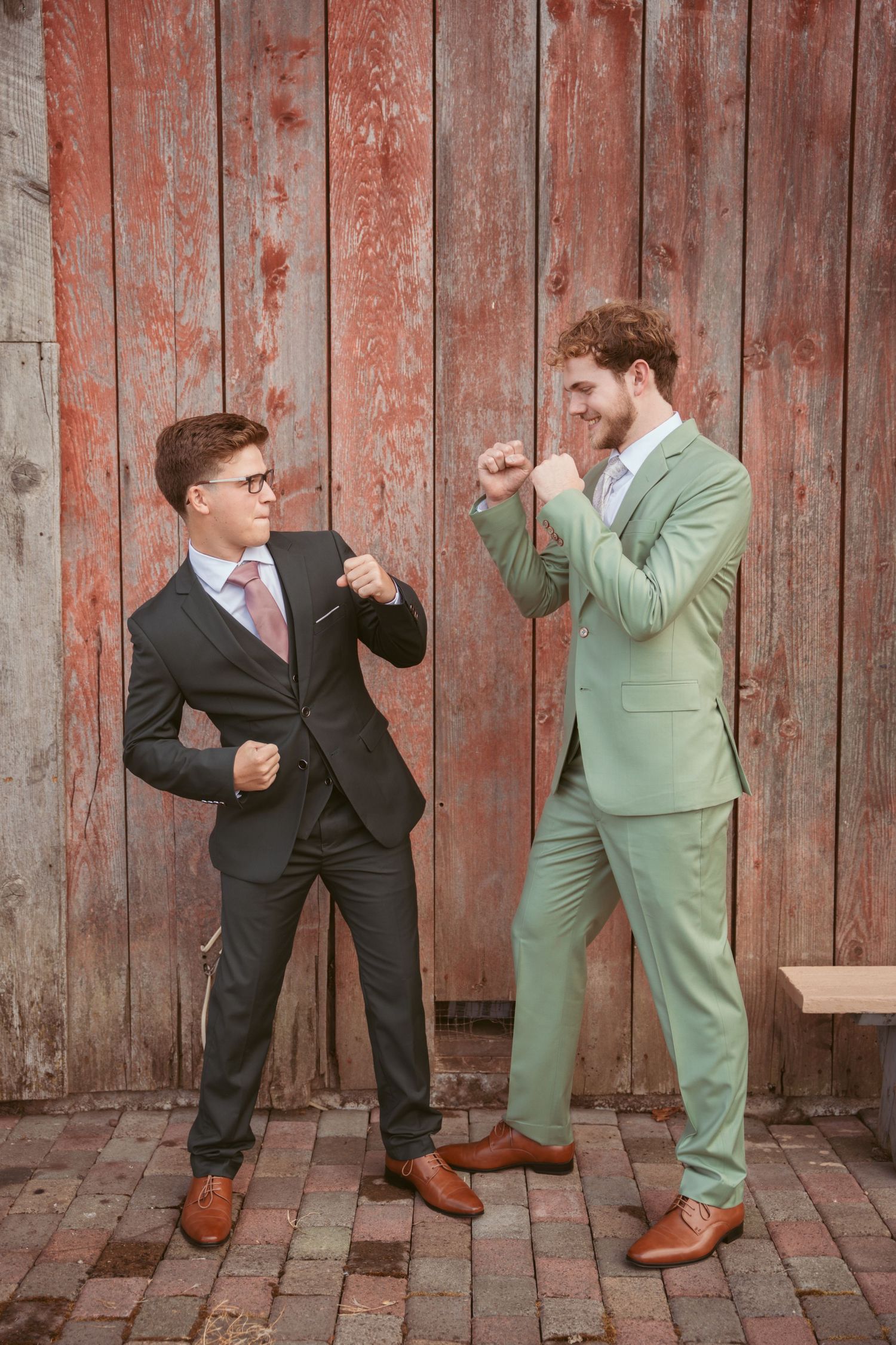 Groomsmen strike fighting poses in a humorous photo sequence against weathered wooden boards.