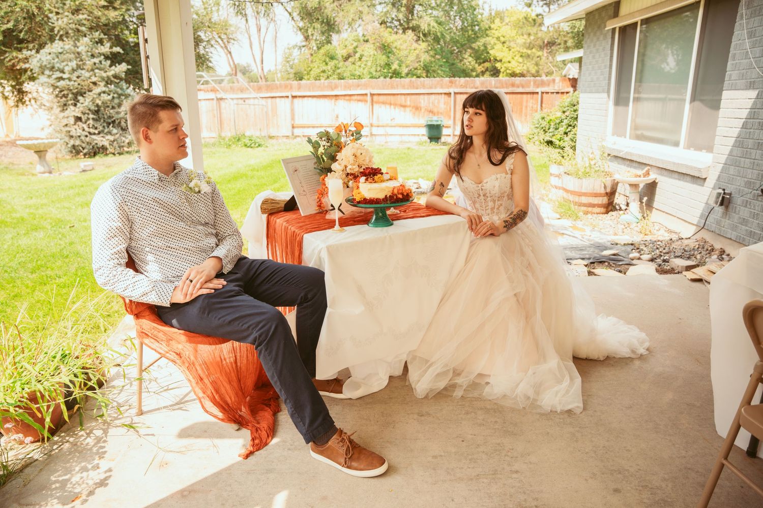 A couple shares quiet moments on a porch with rustic outdoor decor.