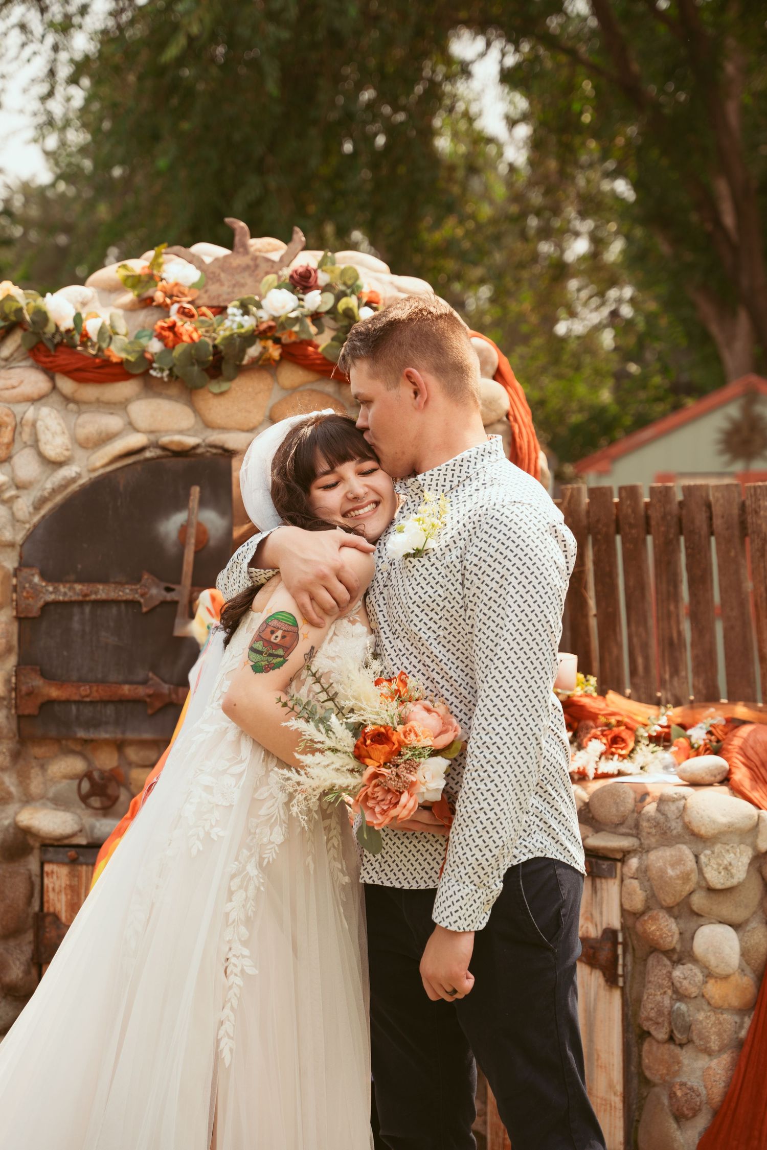 A romantic wedding sequence showing a couple embracing against a rustic stone wall with fall floral decorations.