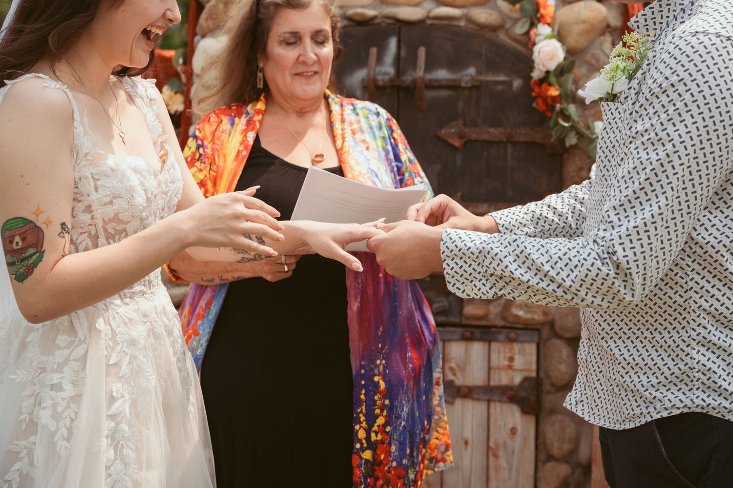 Wedding guests mingling and sharing drinks at an outdoor reception.
