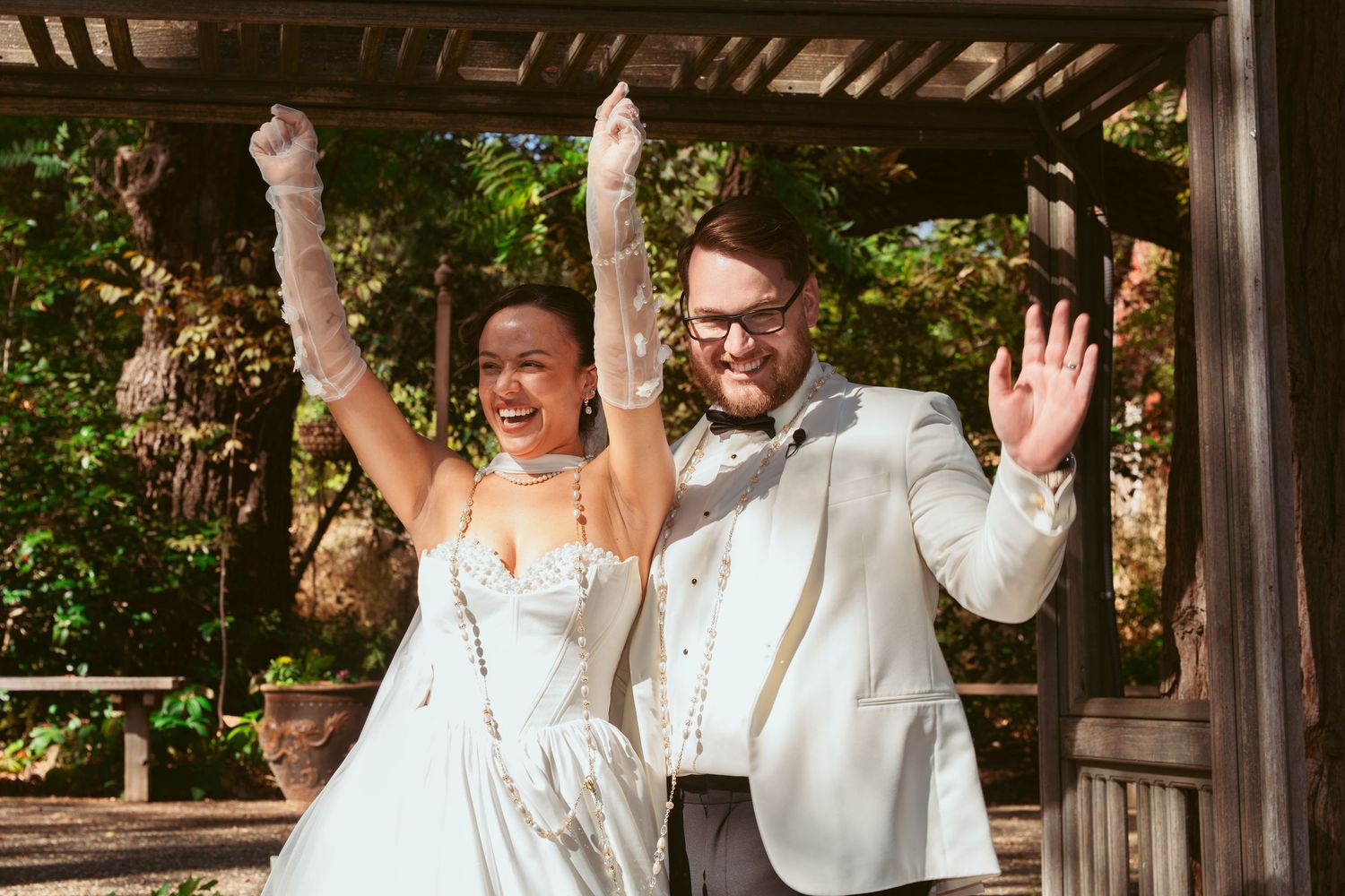 Wedding celebration sequence showing joyful reactions under a wooden pergola in dappled sunlight.