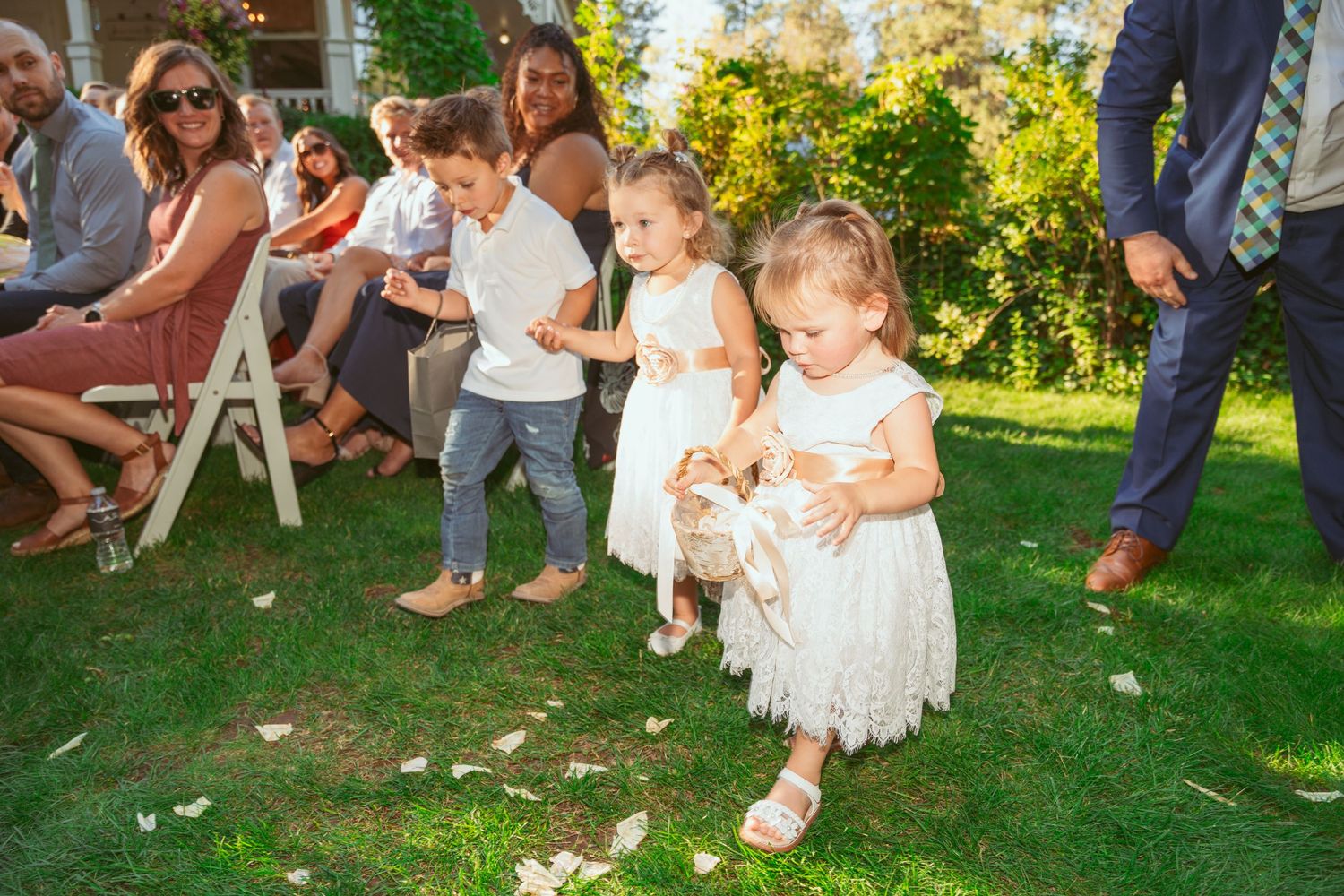 Wedding guests playing lawn games and mingling during an outdoor garden reception.