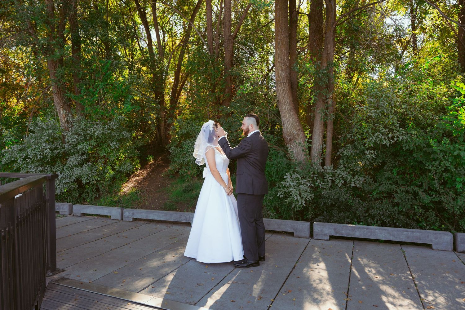 Golden hour wedding photos showing intimate moments between newlyweds on a wooden deck.