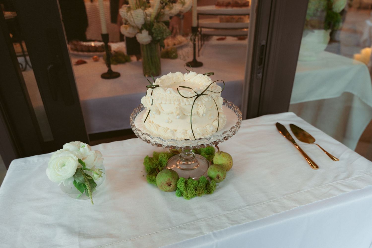 White floral centerpieces arranged along a formal table setting.