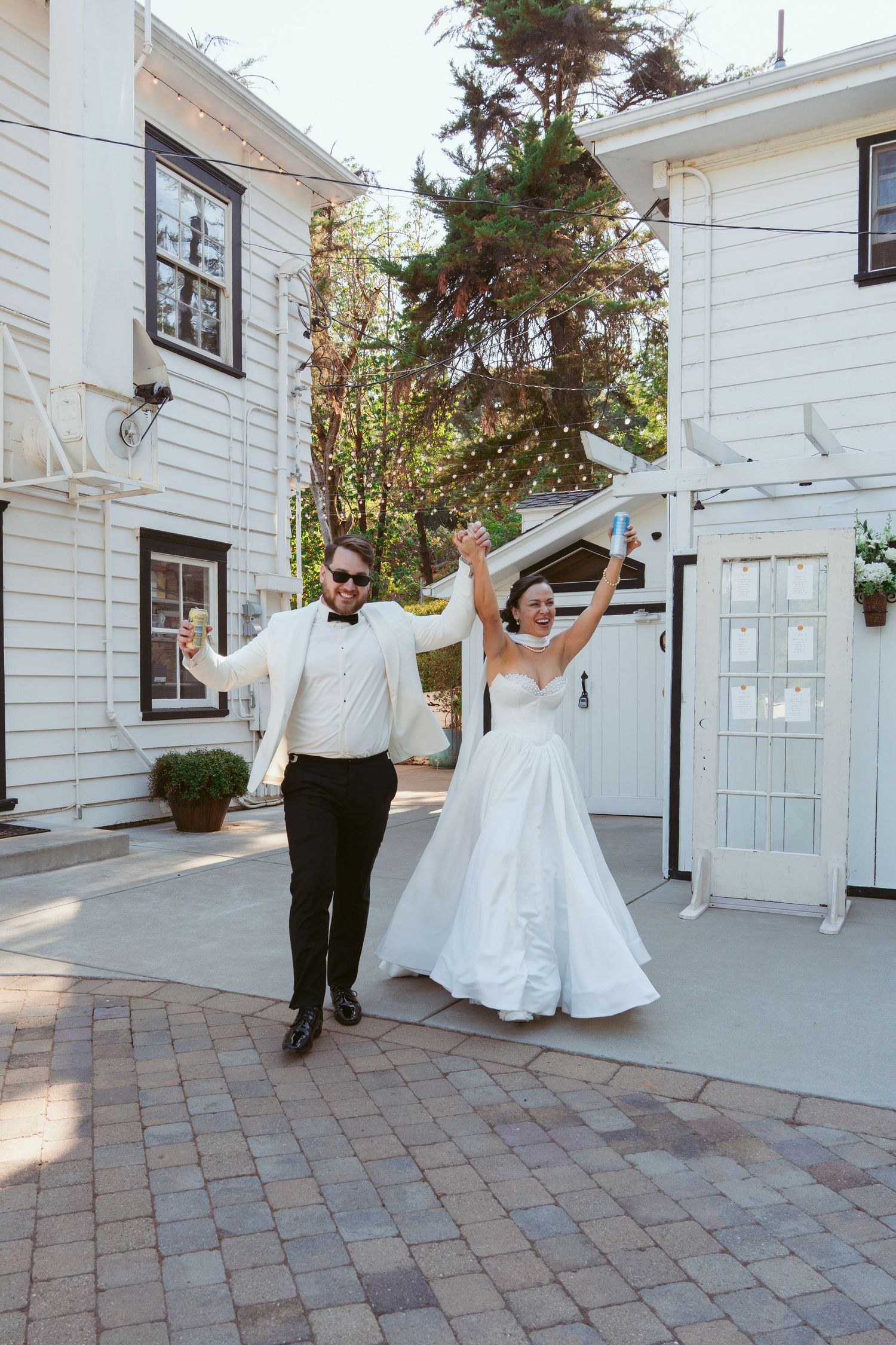 Sequence of wedding photos showing a couple dancing and twirling outside a white building on a brick patio.