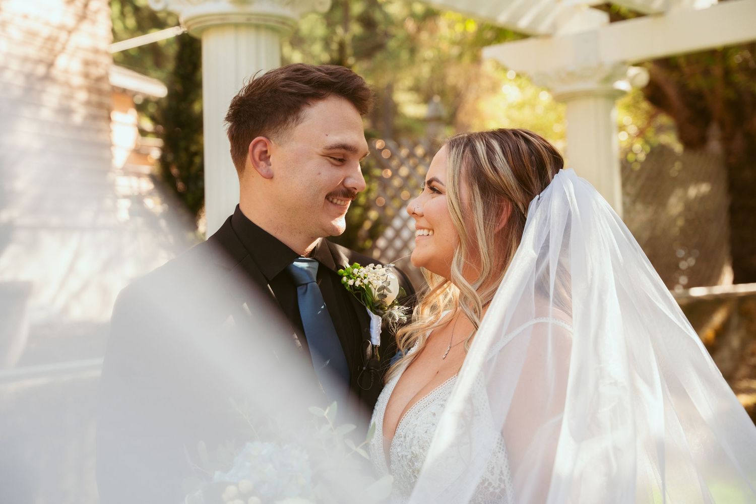 Intimate wedding portraits captured in golden afternoon light with soft focus.