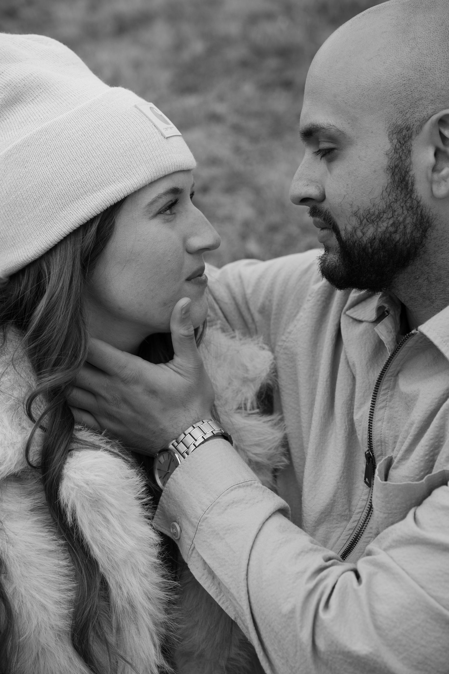 Black and white portraits of couple in winter attire sharing intimate moments outdoors.