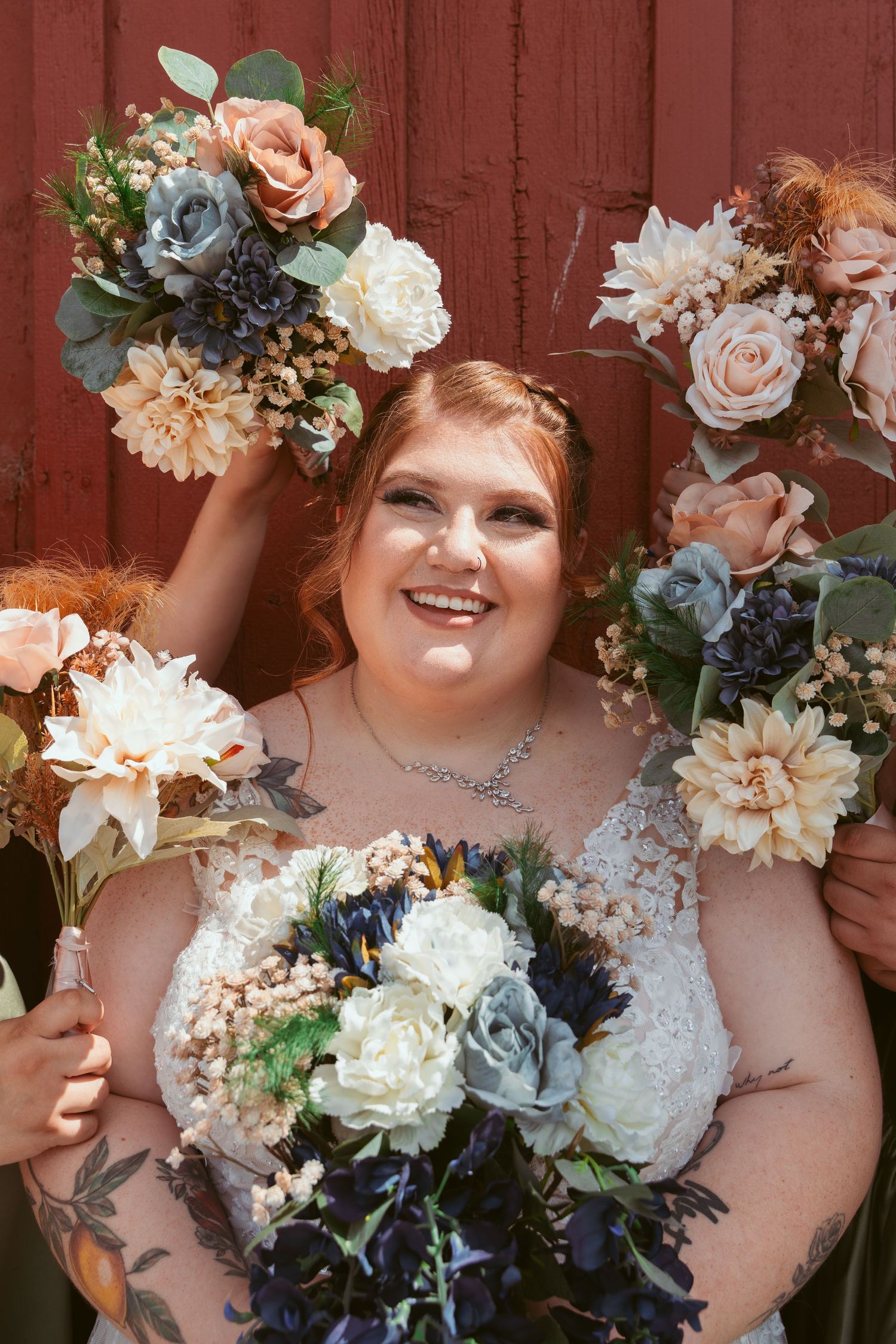 A wedding bouquet series featuring peach roses, white peonies and blue hydrangeas against a rustic red barn wall.